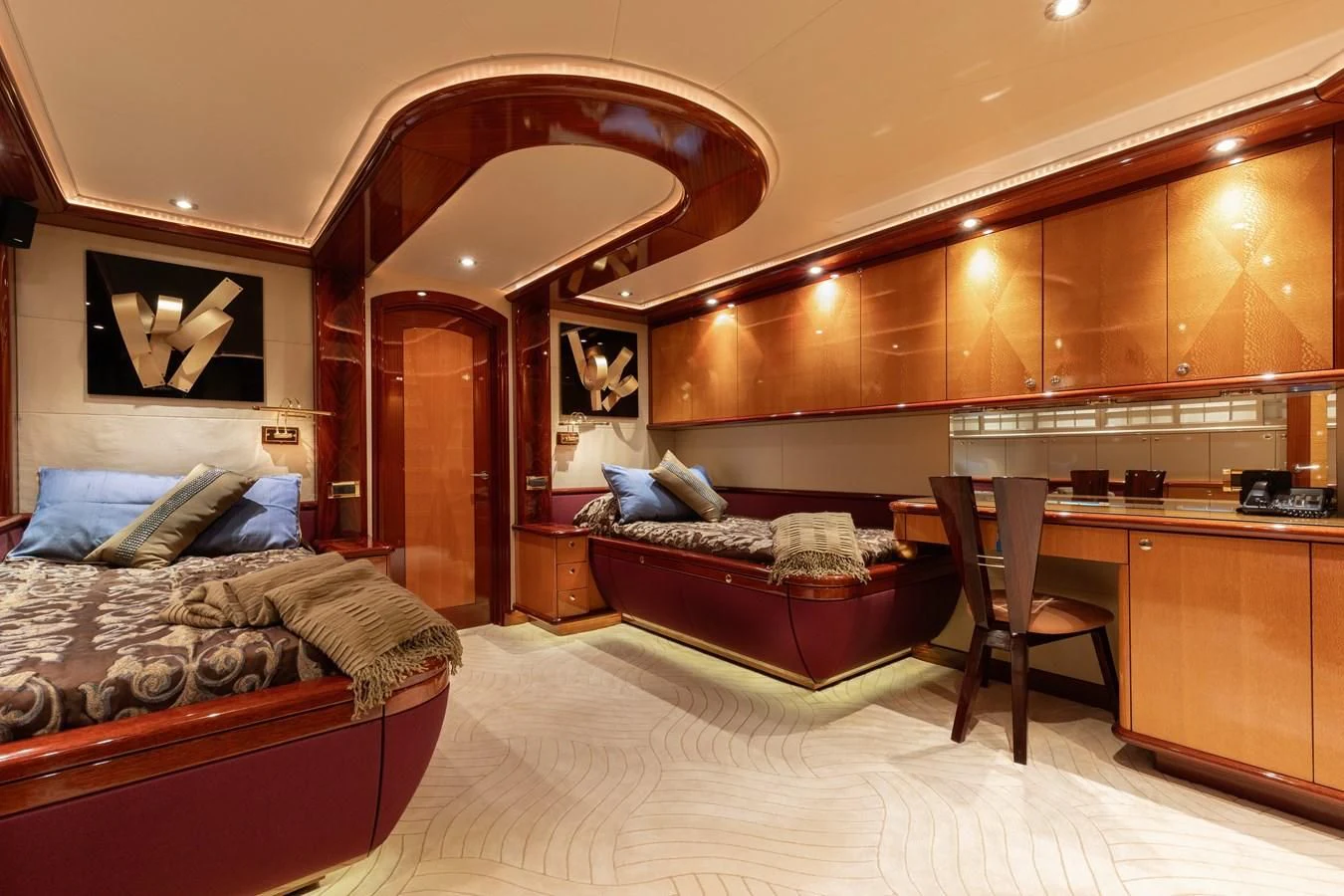 a bedroom with a bed and a desk aboard DRIVEN Yacht for Sale