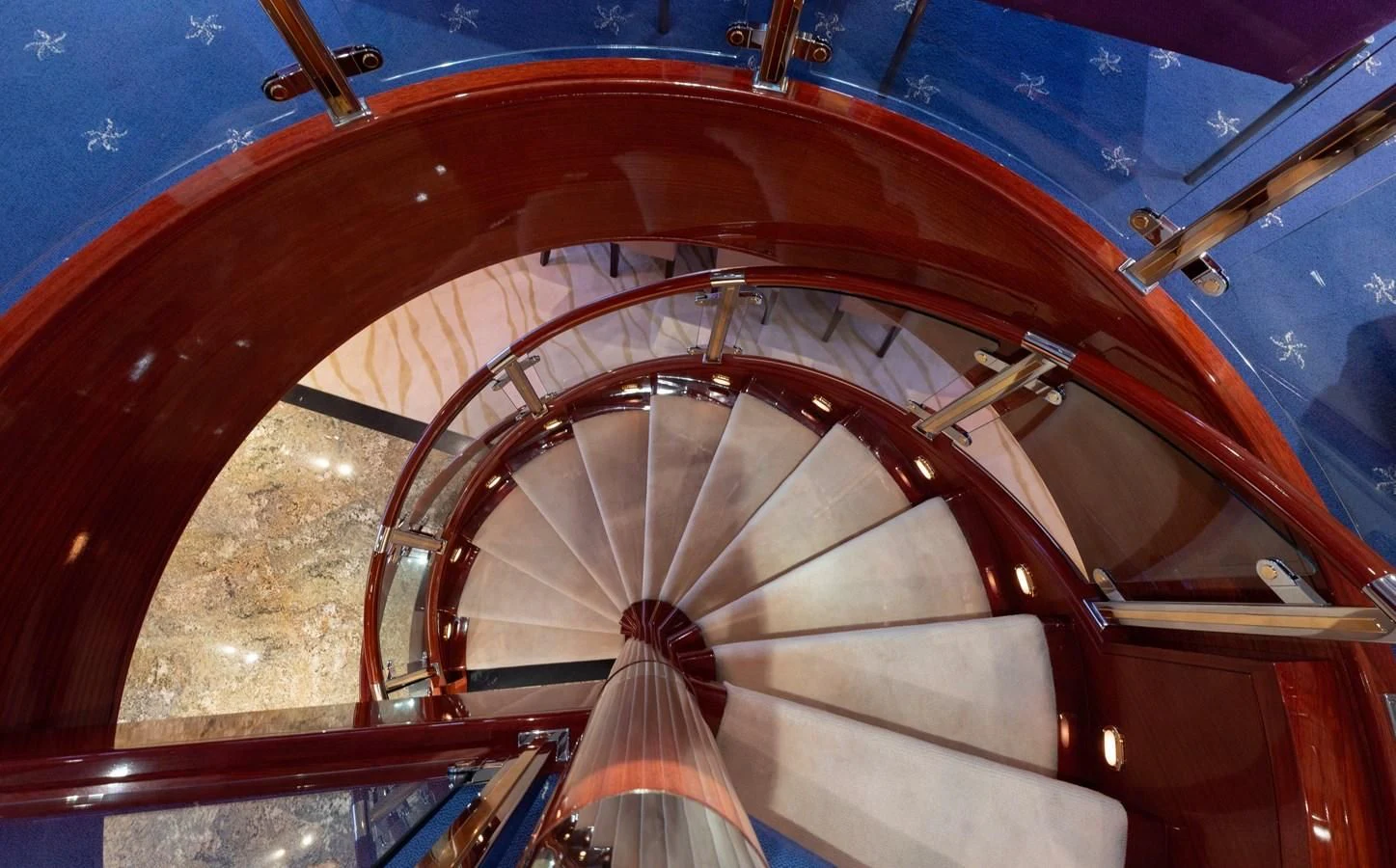 a close-up of a spiral staircase aboard DRIVEN Yacht for Sale