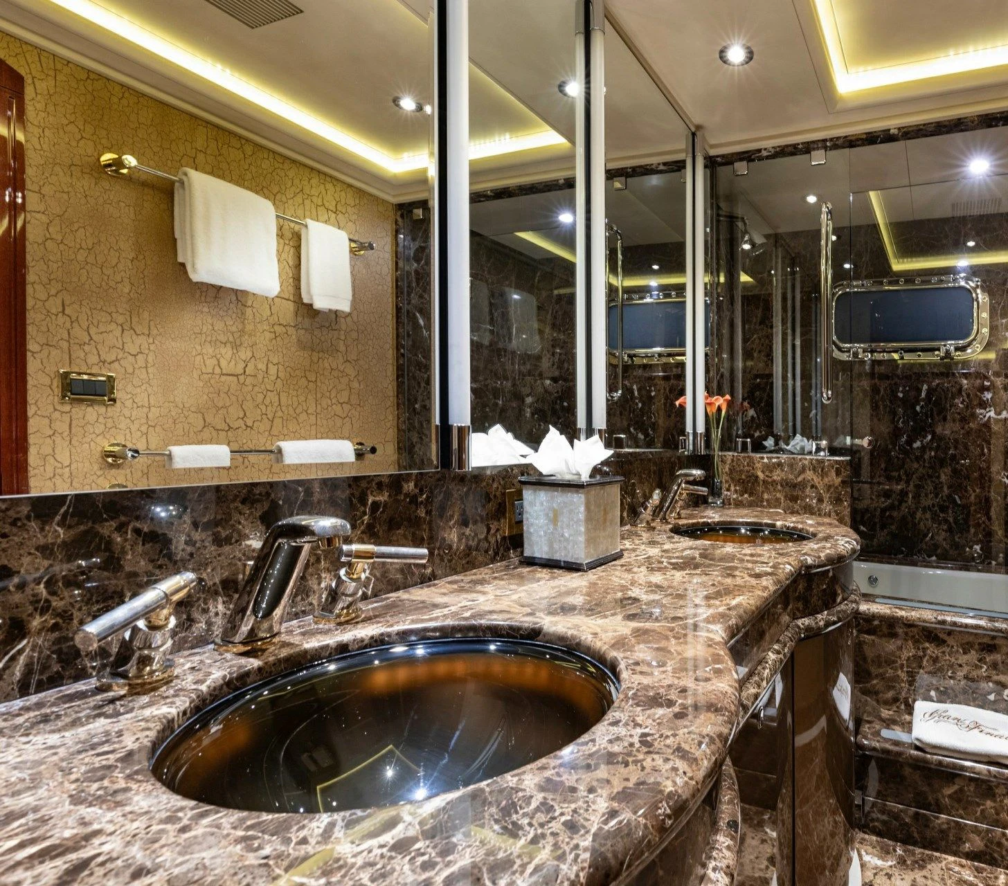 a bathroom with a marble countertop aboard DRIVEN Yacht for Sale