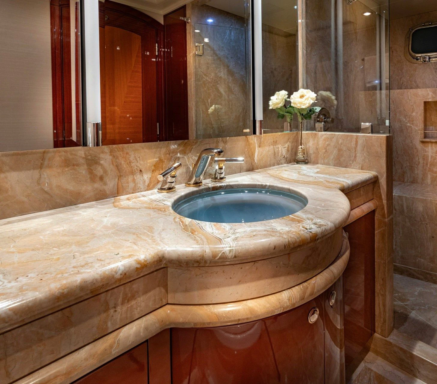 a bathroom with a sink and a mirror aboard DRIVEN Yacht for Sale