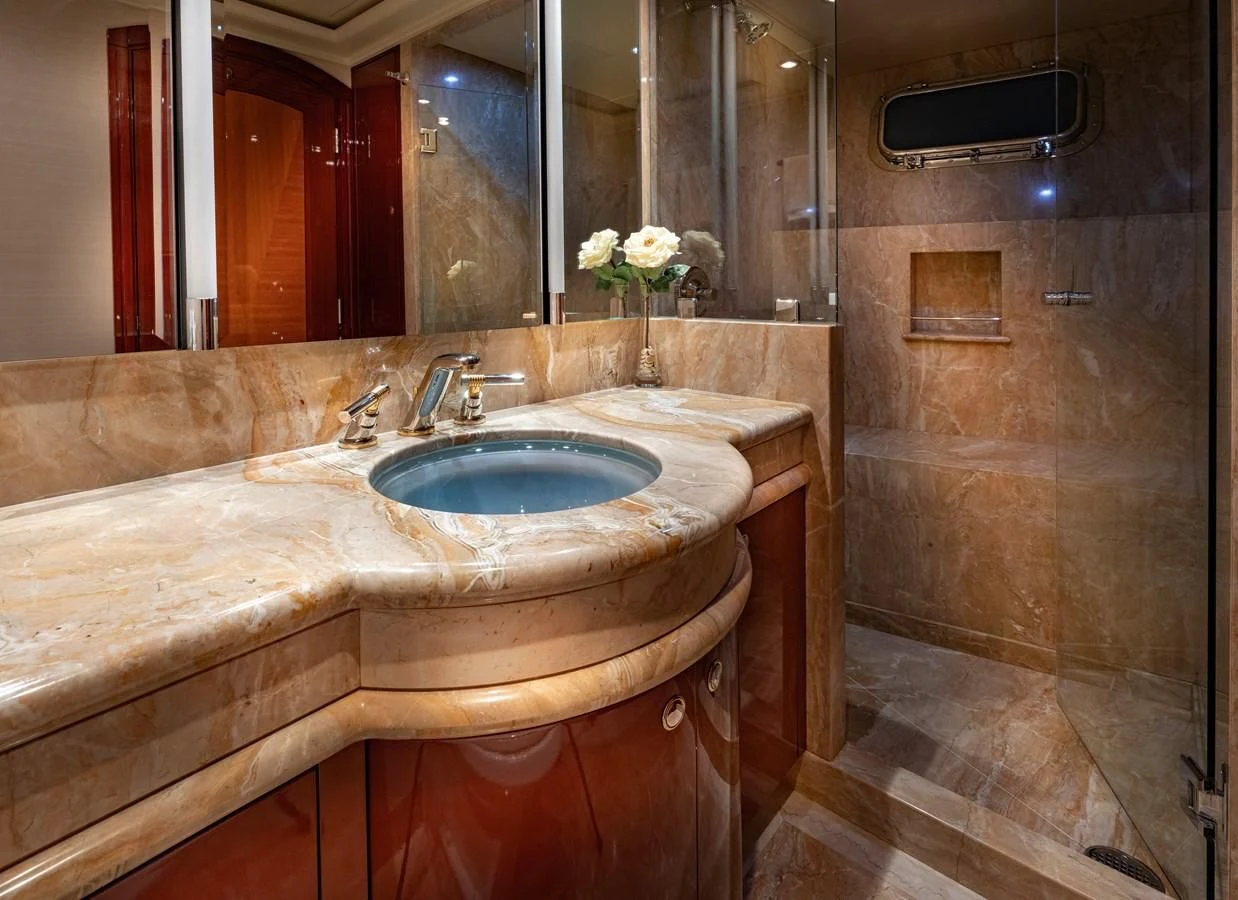 a bathroom with a sink and a mirror aboard DRIVEN Yacht for Sale