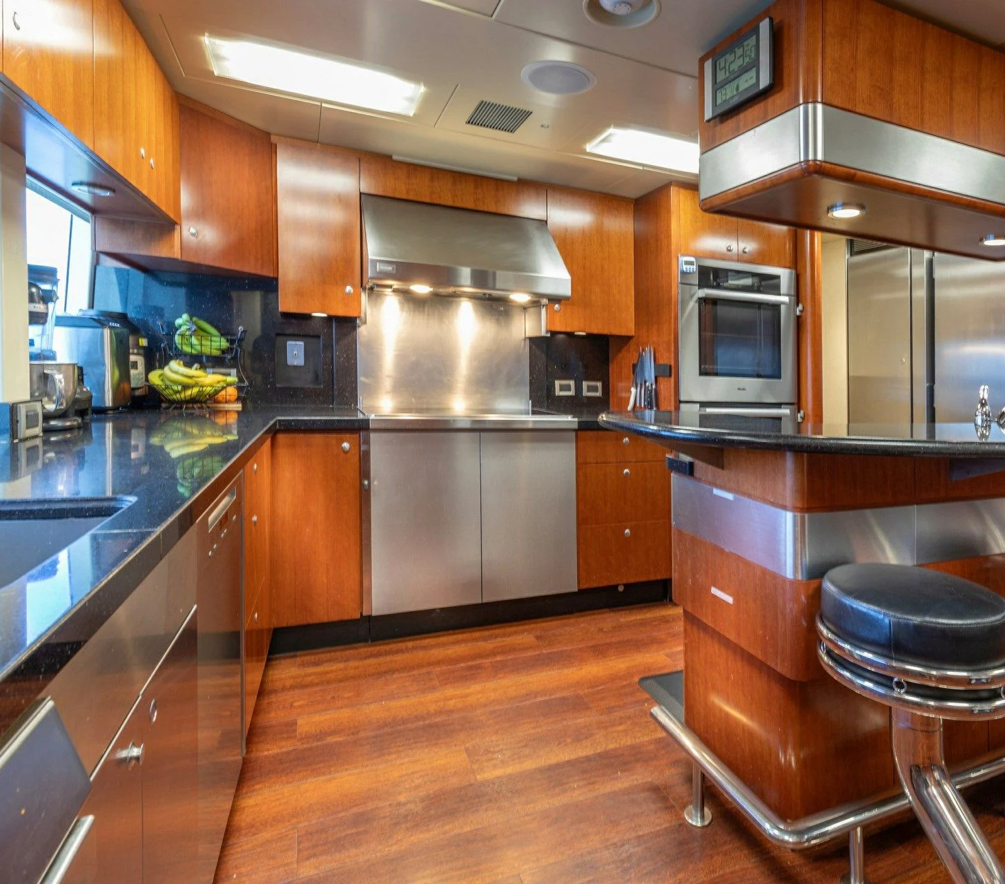 a kitchen with wooden cabinets aboard DRIVEN Yacht for Sale