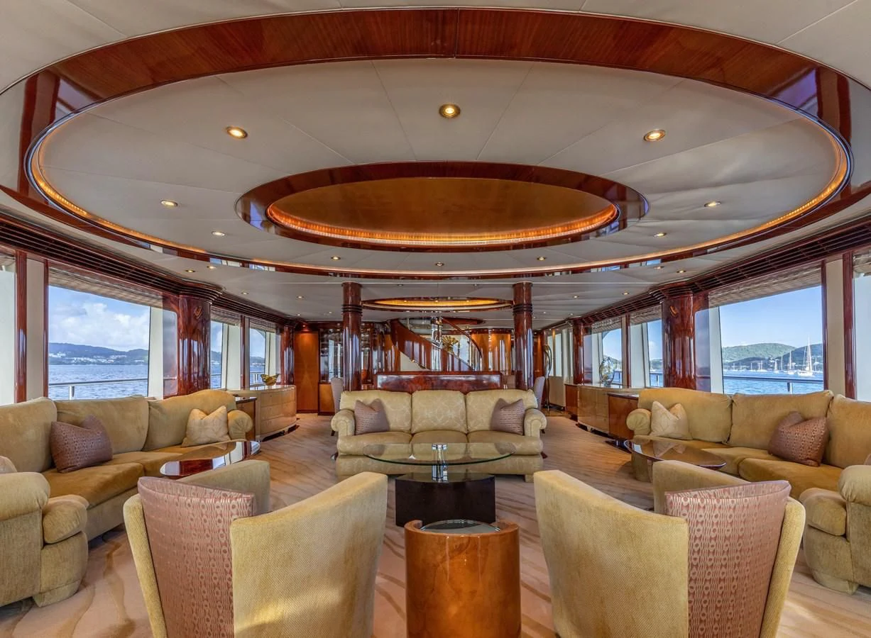 a living room with a large chandelier aboard DRIVEN Yacht for Sale