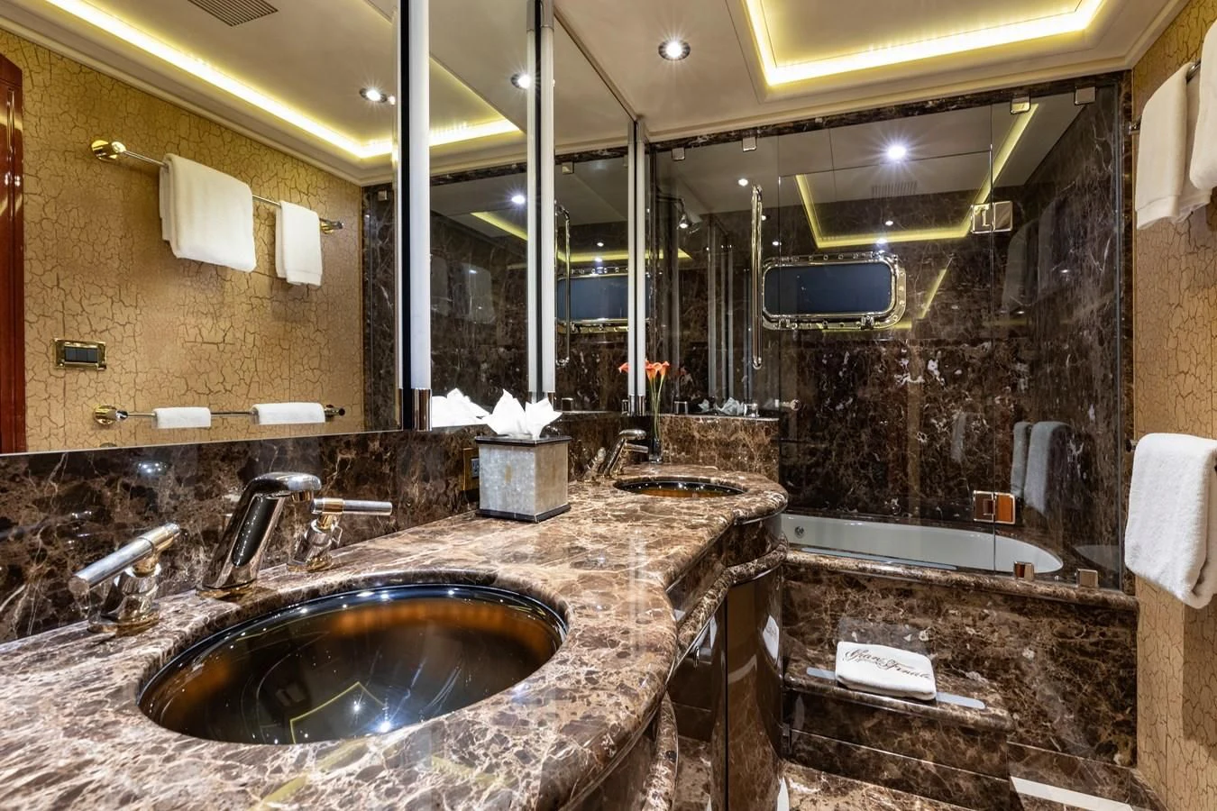 a bathroom with a large marble counter aboard DRIVEN Yacht for Sale
