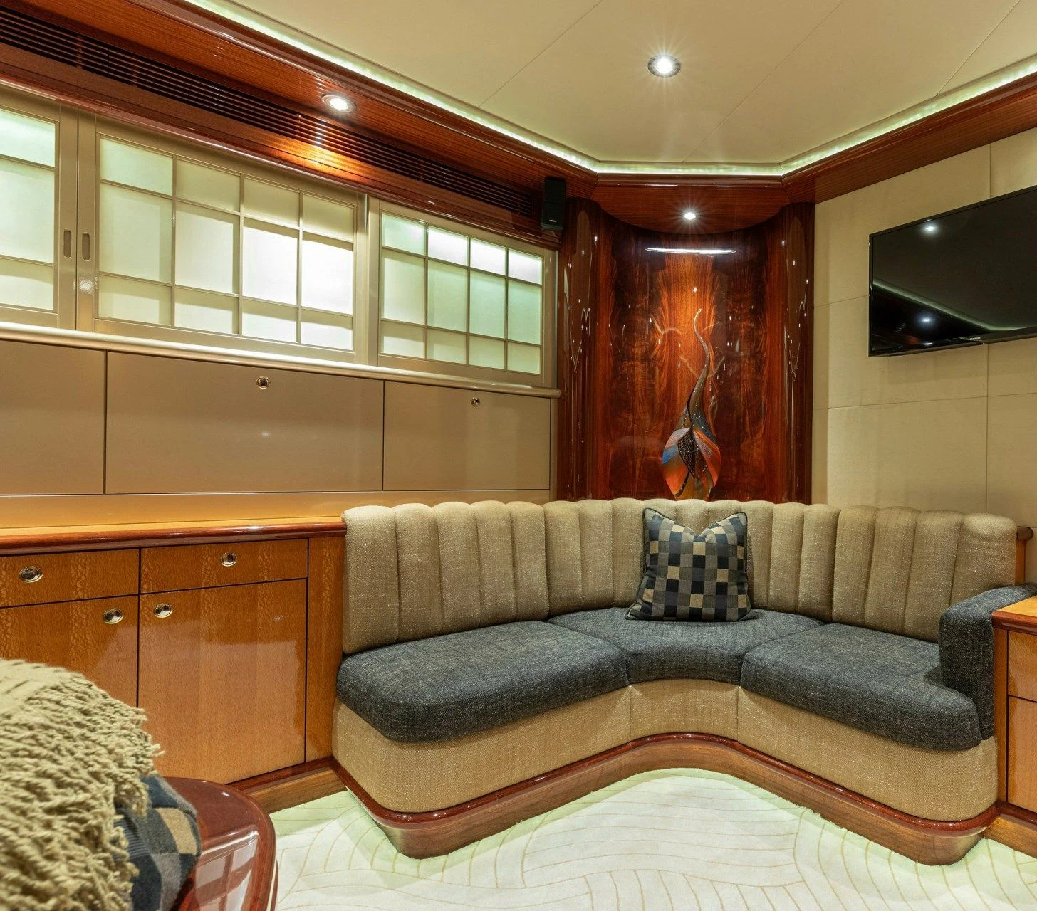 a living room with a couch aboard DRIVEN Yacht for Sale