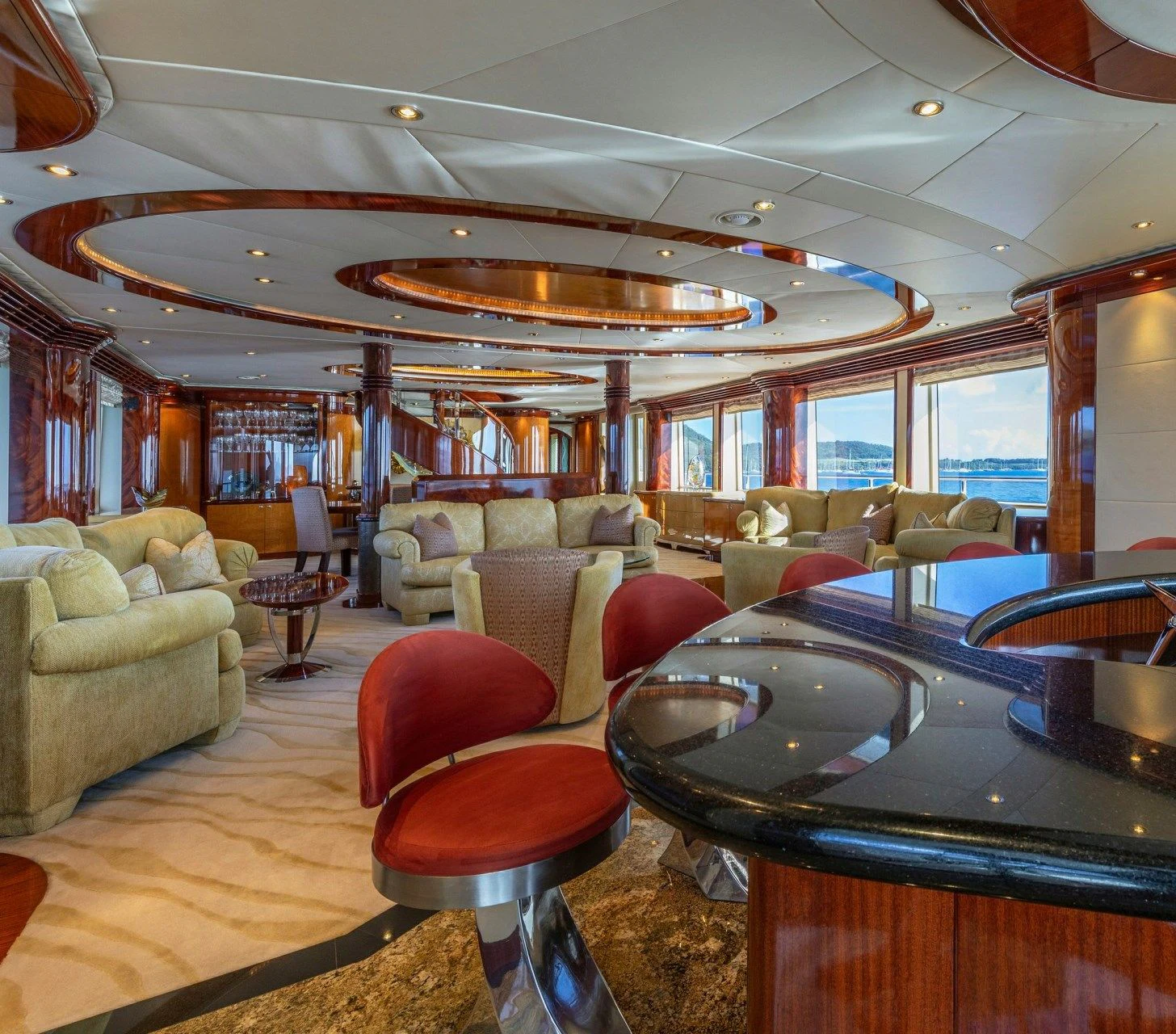 a room with a bar and a table and chairs aboard DRIVEN Yacht for Sale