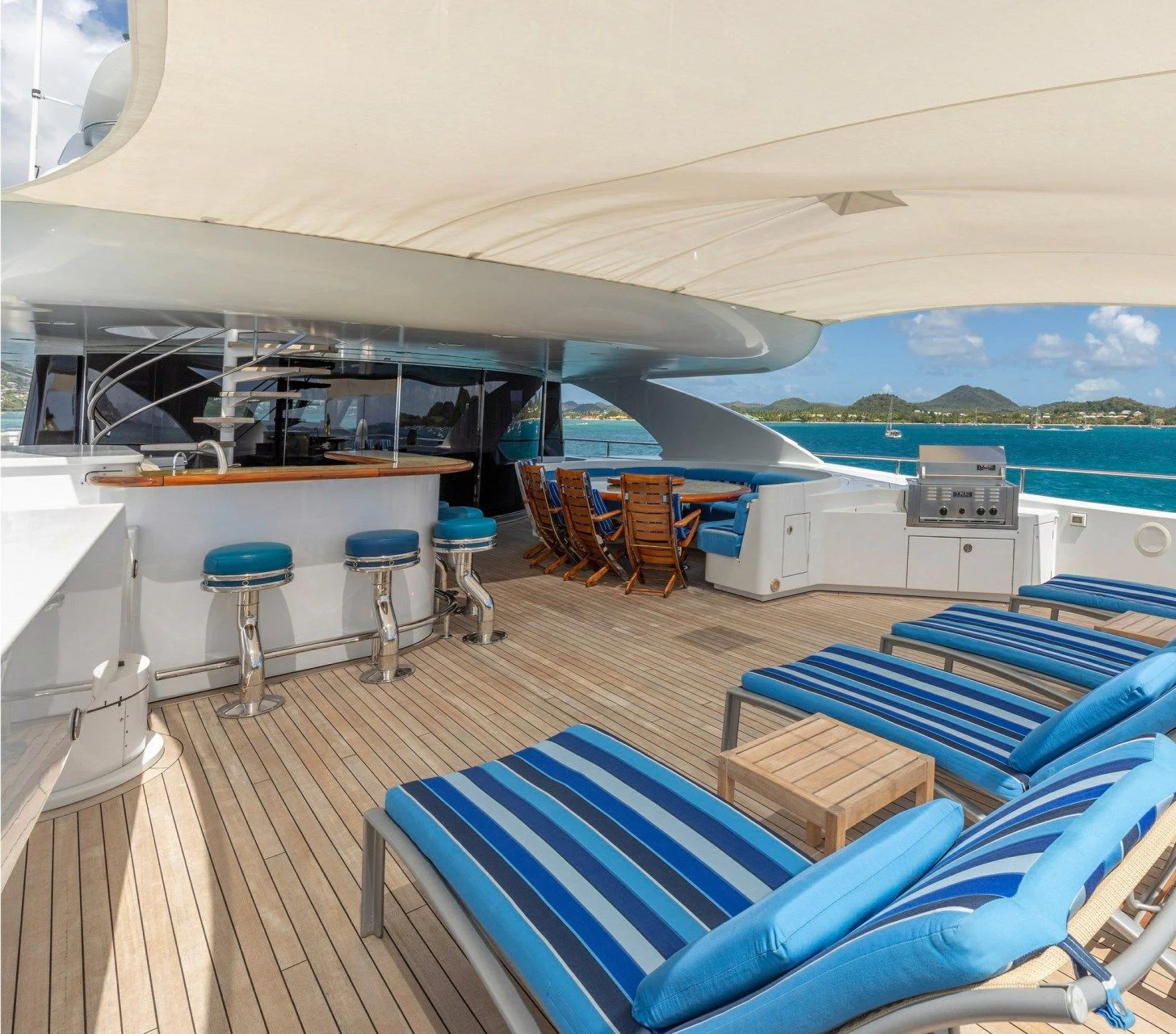a boat deck with chairs and tables aboard DRIVEN Yacht for Sale