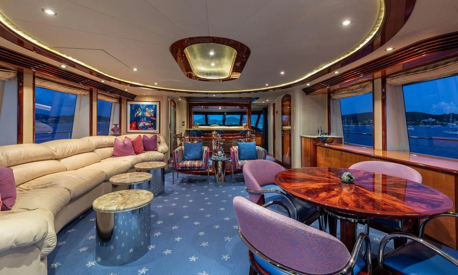 a living room with a large table and chairs aboard DRIVEN Yacht for Sale
