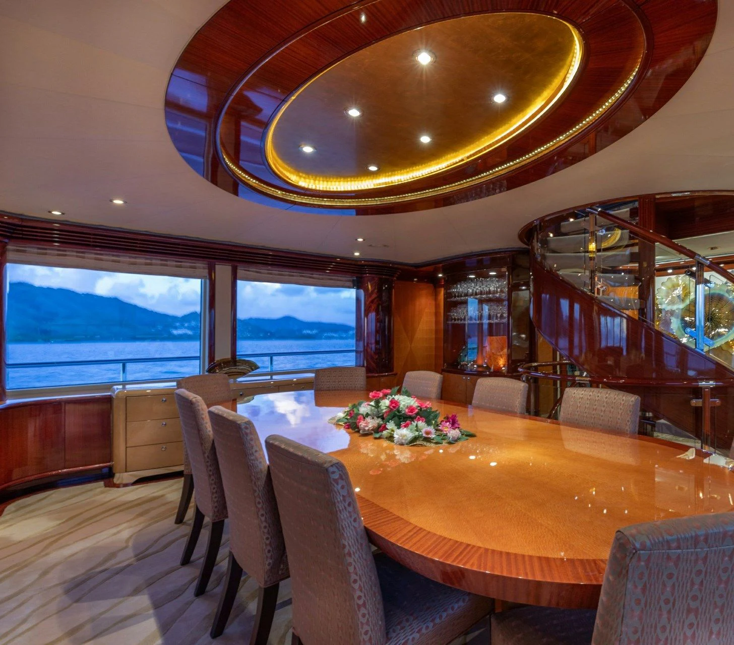 a large dining room with a large window overlooking a city aboard DRIVEN Yacht for Sale