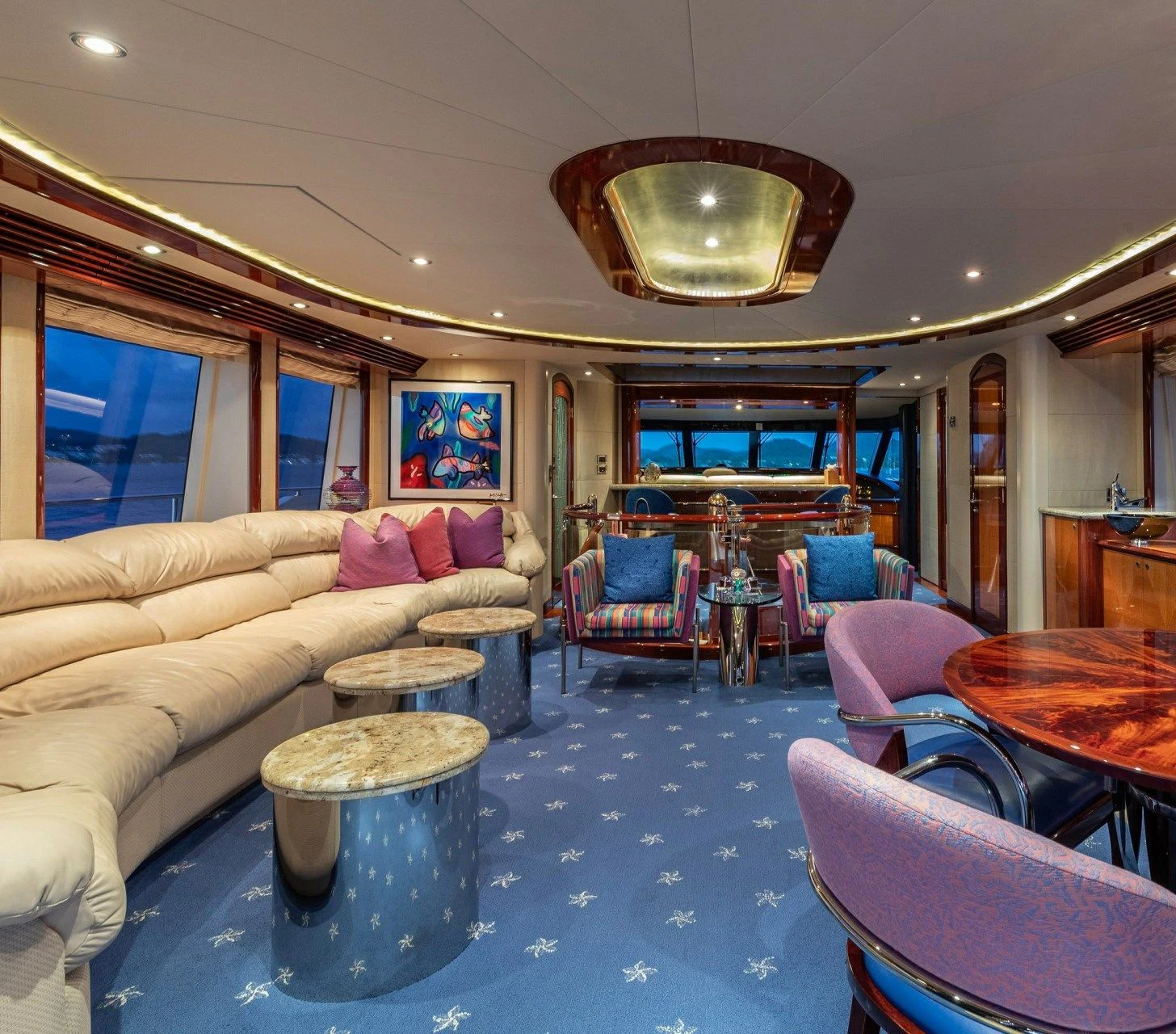 a living room with a couch and a table aboard DRIVEN Yacht for Sale