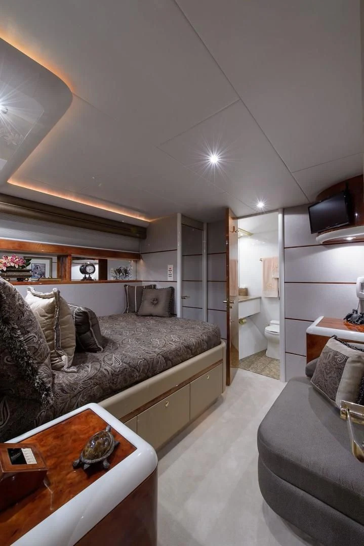a living room with a couch and a coffee table aboard BIG WAVE Yacht for Sale