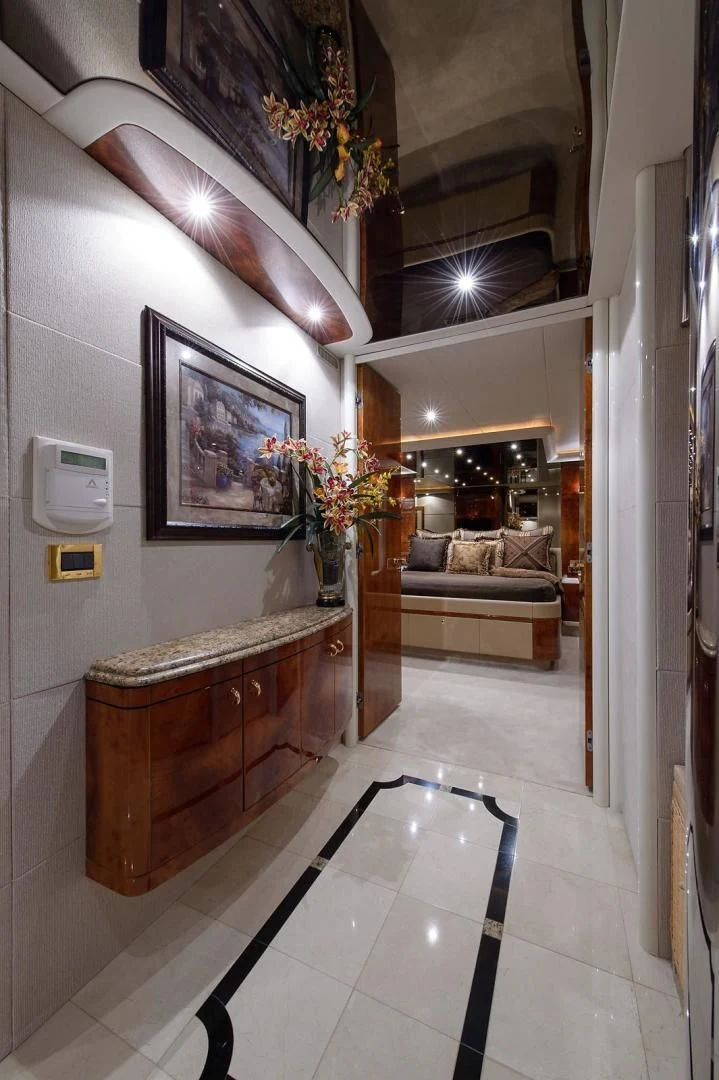 a room with a table and couch aboard BIG WAVE Yacht for Sale