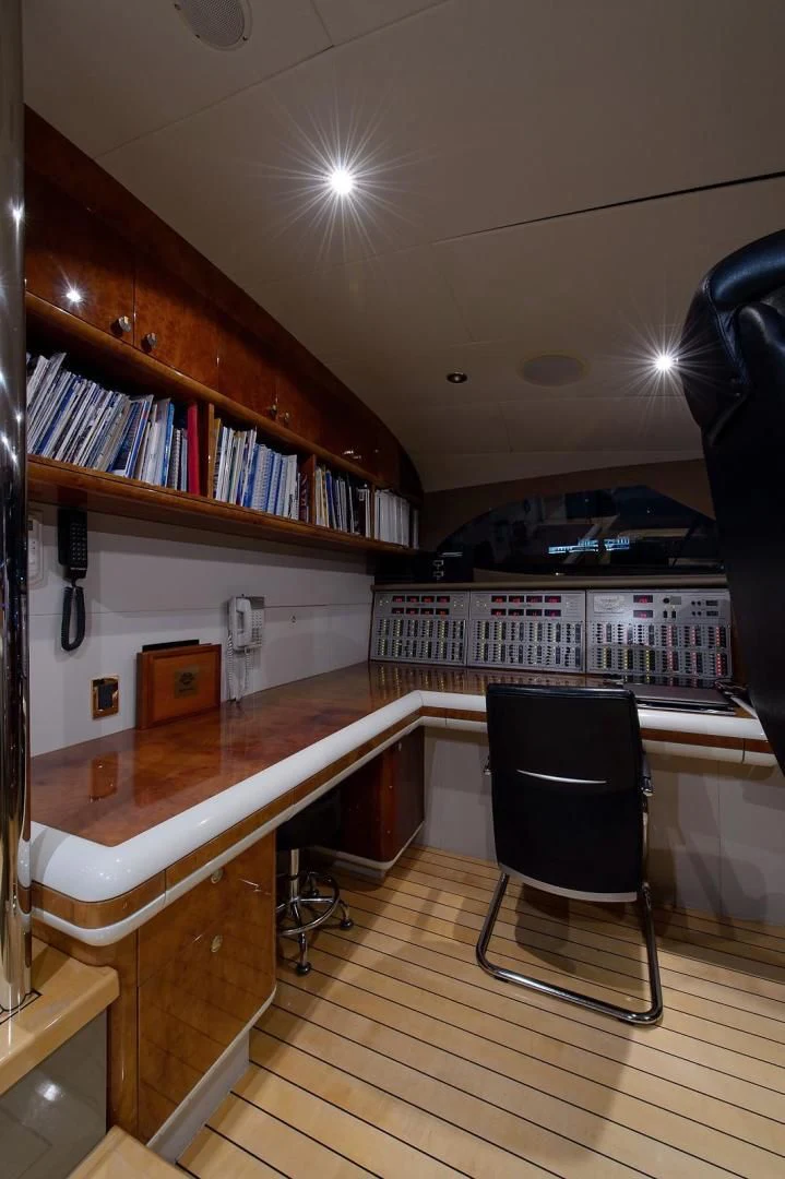 a room with a desk and a chair aboard BIG WAVE Yacht for Sale