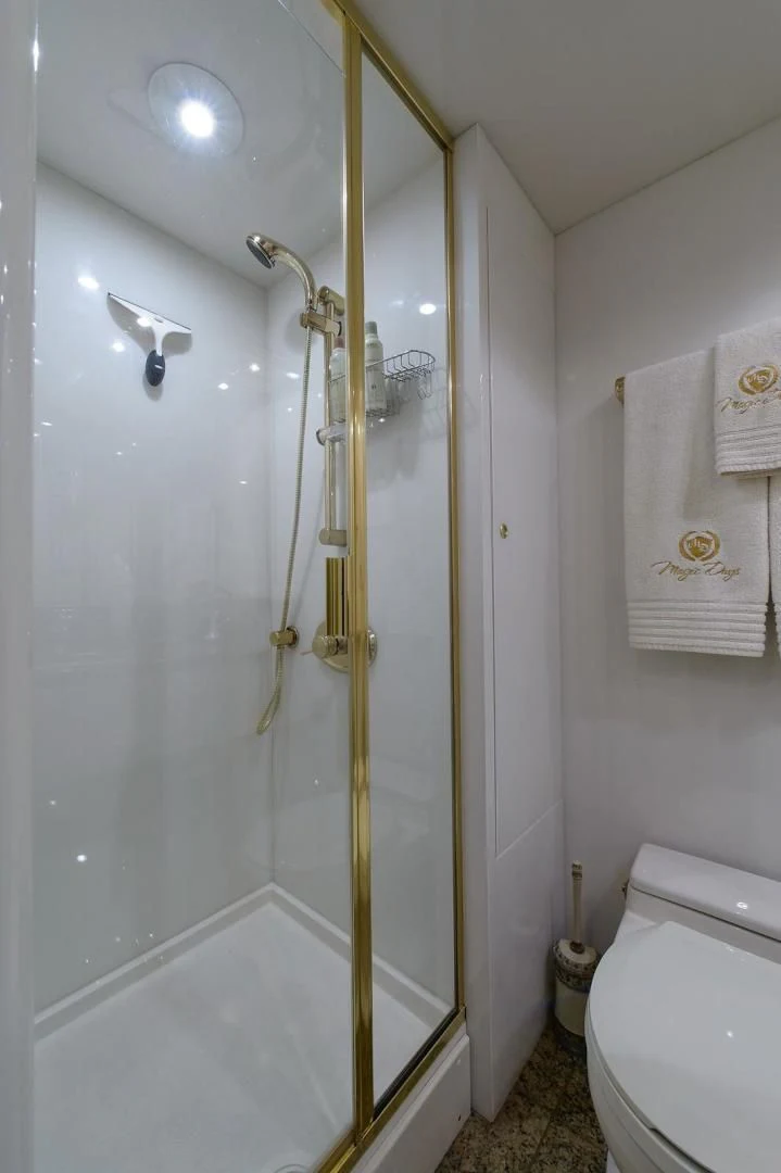 a bathroom with a shower unit aboard BIG WAVE Yacht for Sale