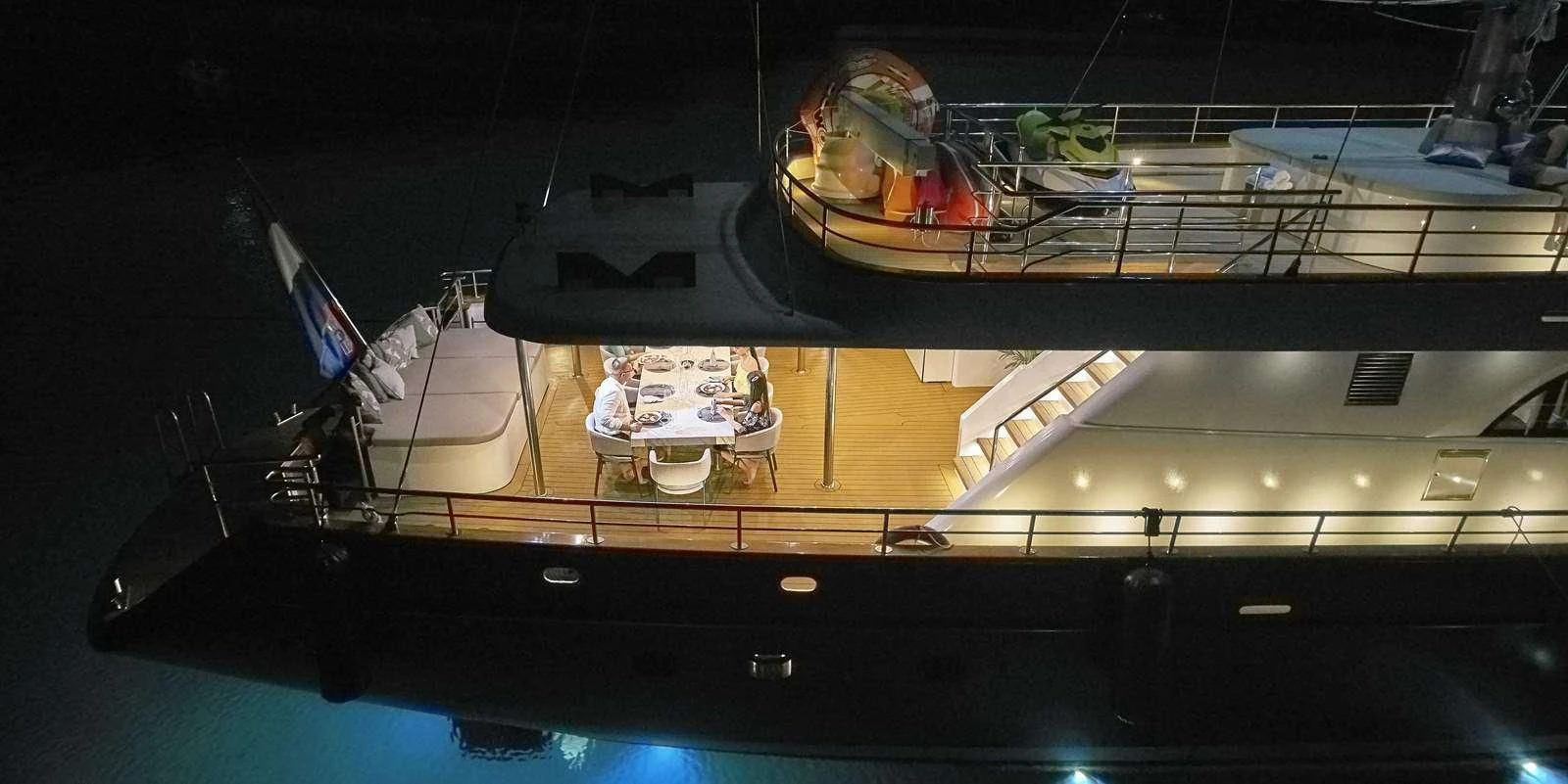 a large room with a large table and chairs and a large window aboard DALMATINO Yacht for Sale