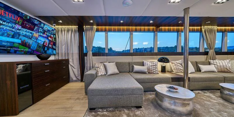 a living room with a large sofa aboard DALMATINO Yacht for Sale