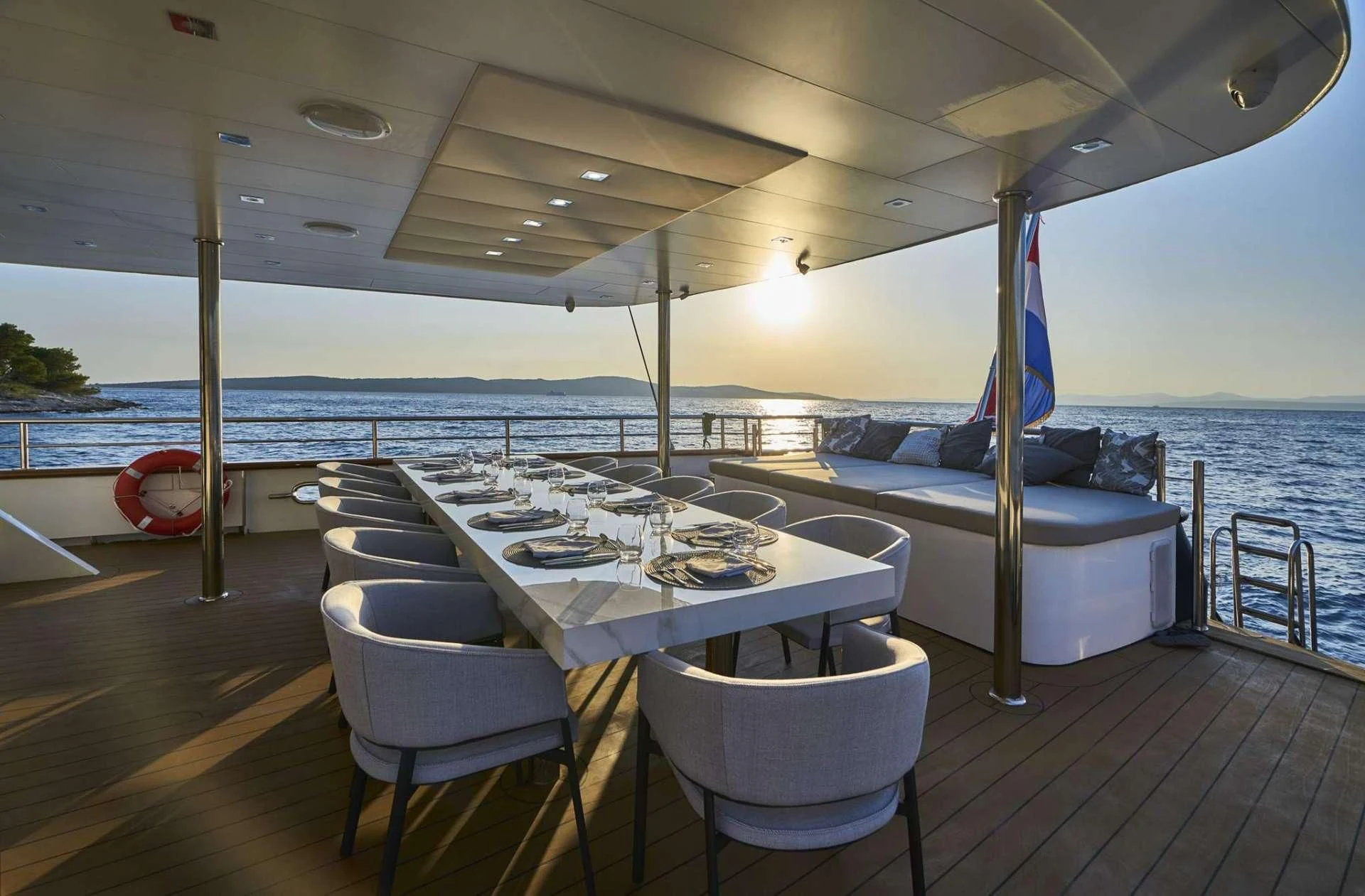 a table and chairs on a deck aboard DALMATINO Yacht for Sale