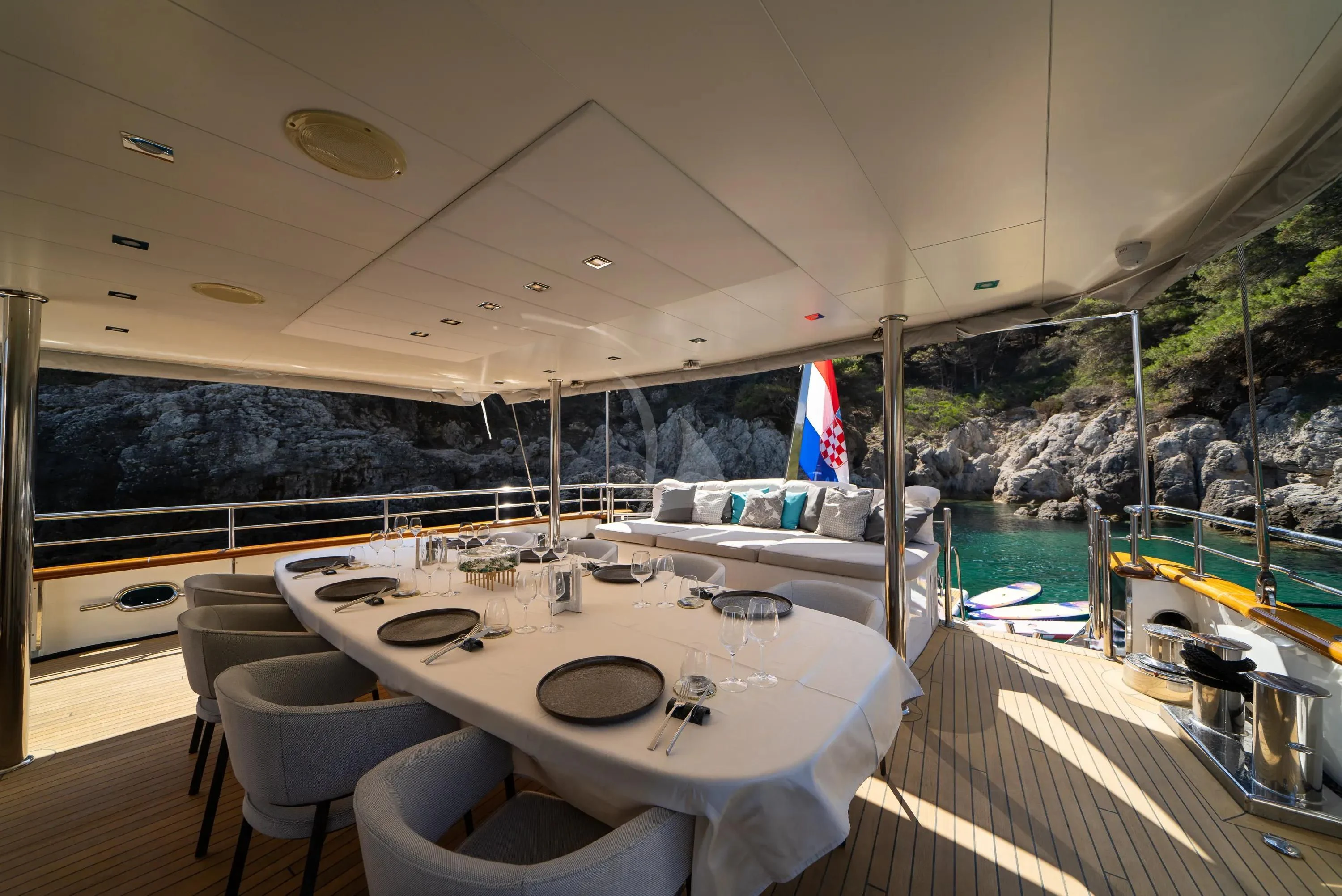 a large white table with a round white table and chairs aboard DALMATINO Yacht for Sale