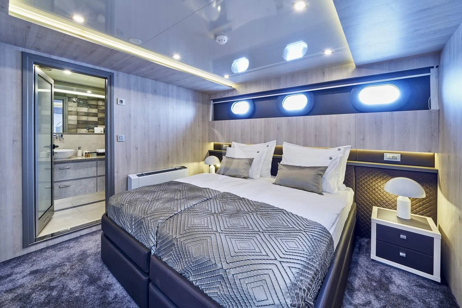 a bedroom with a bed and a mirror aboard DALMATINO Yacht for Sale