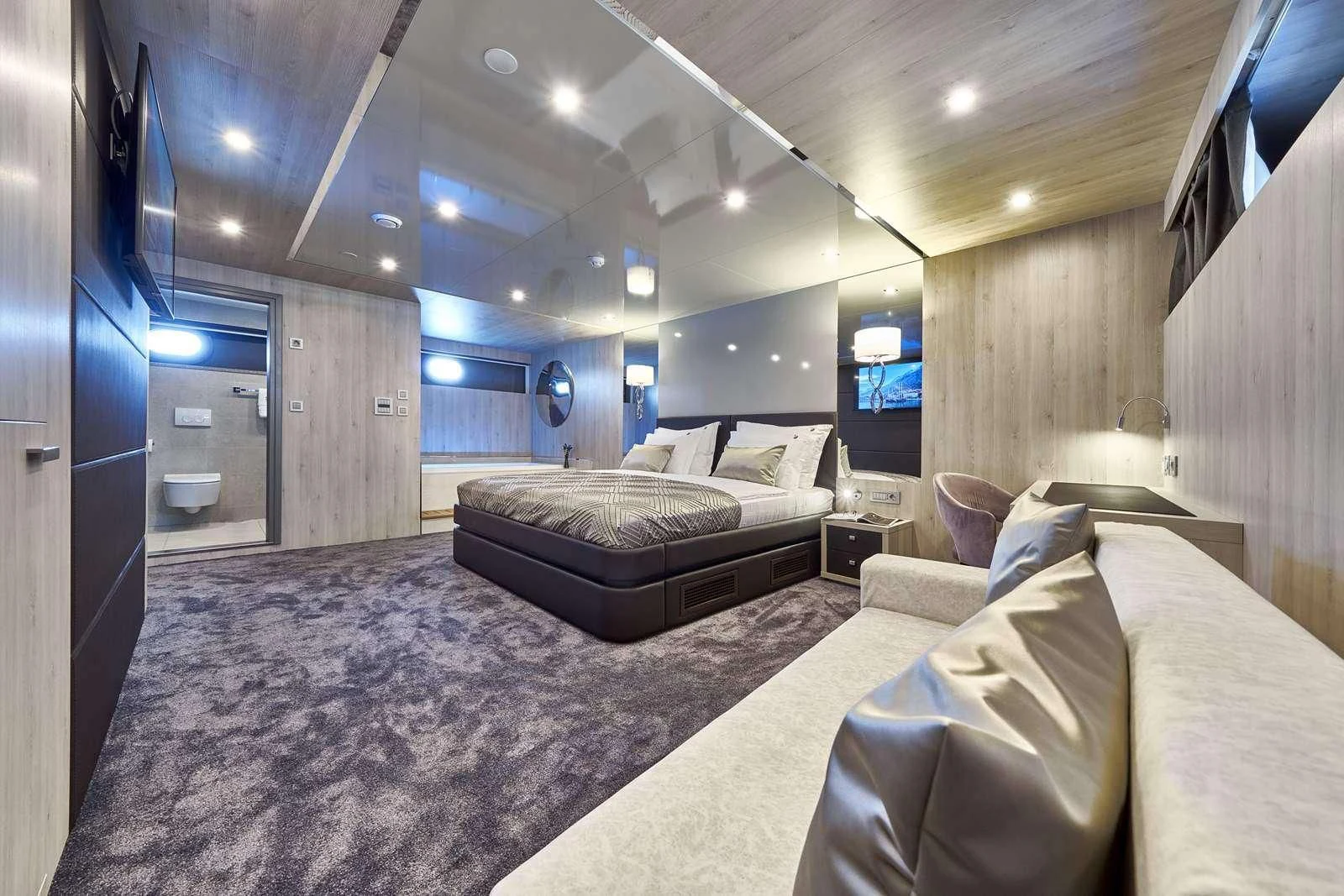 a room with a bed and a tv aboard DALMATINO Yacht for Sale