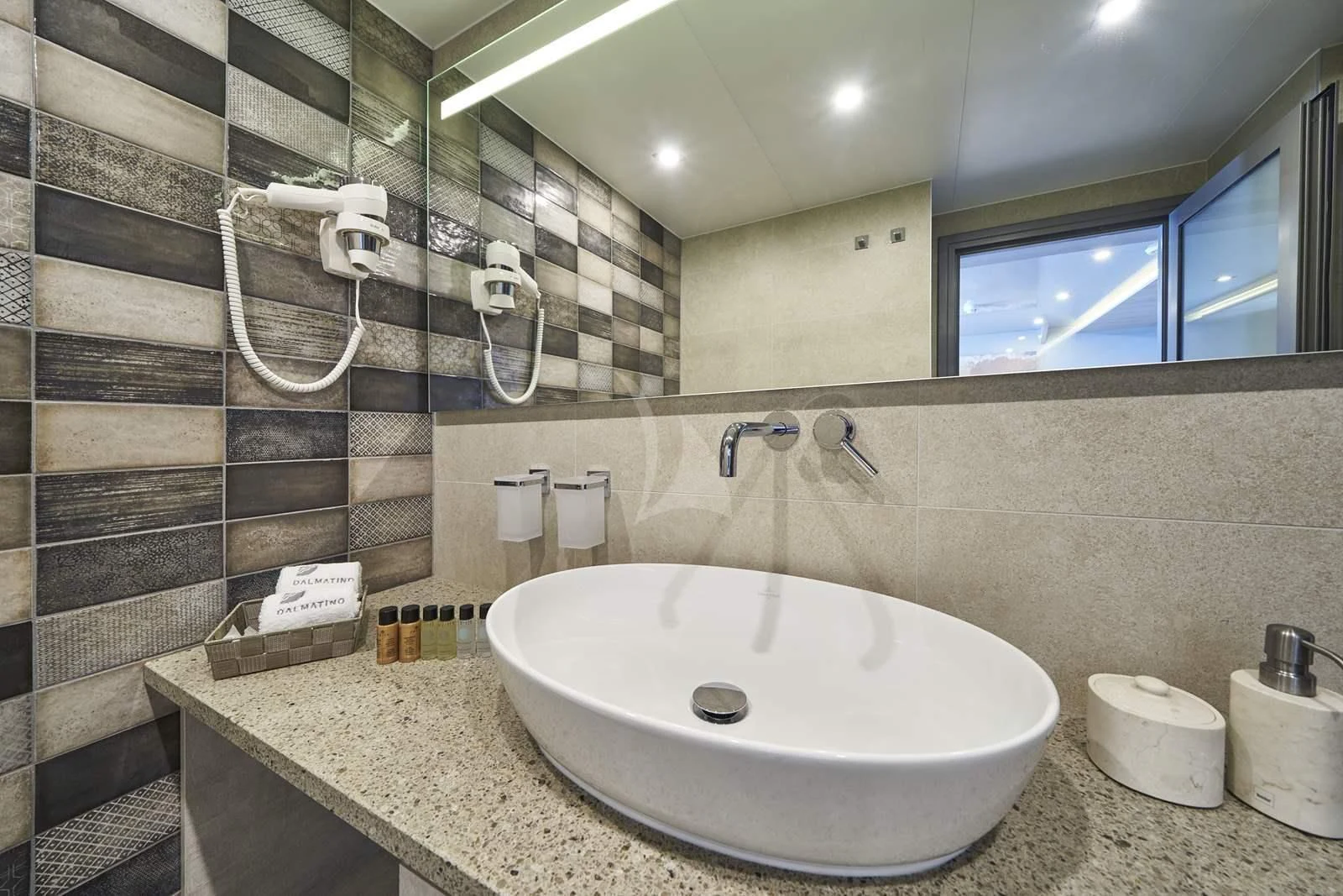 a bathroom with a large mirror aboard DALMATINO Yacht for Sale