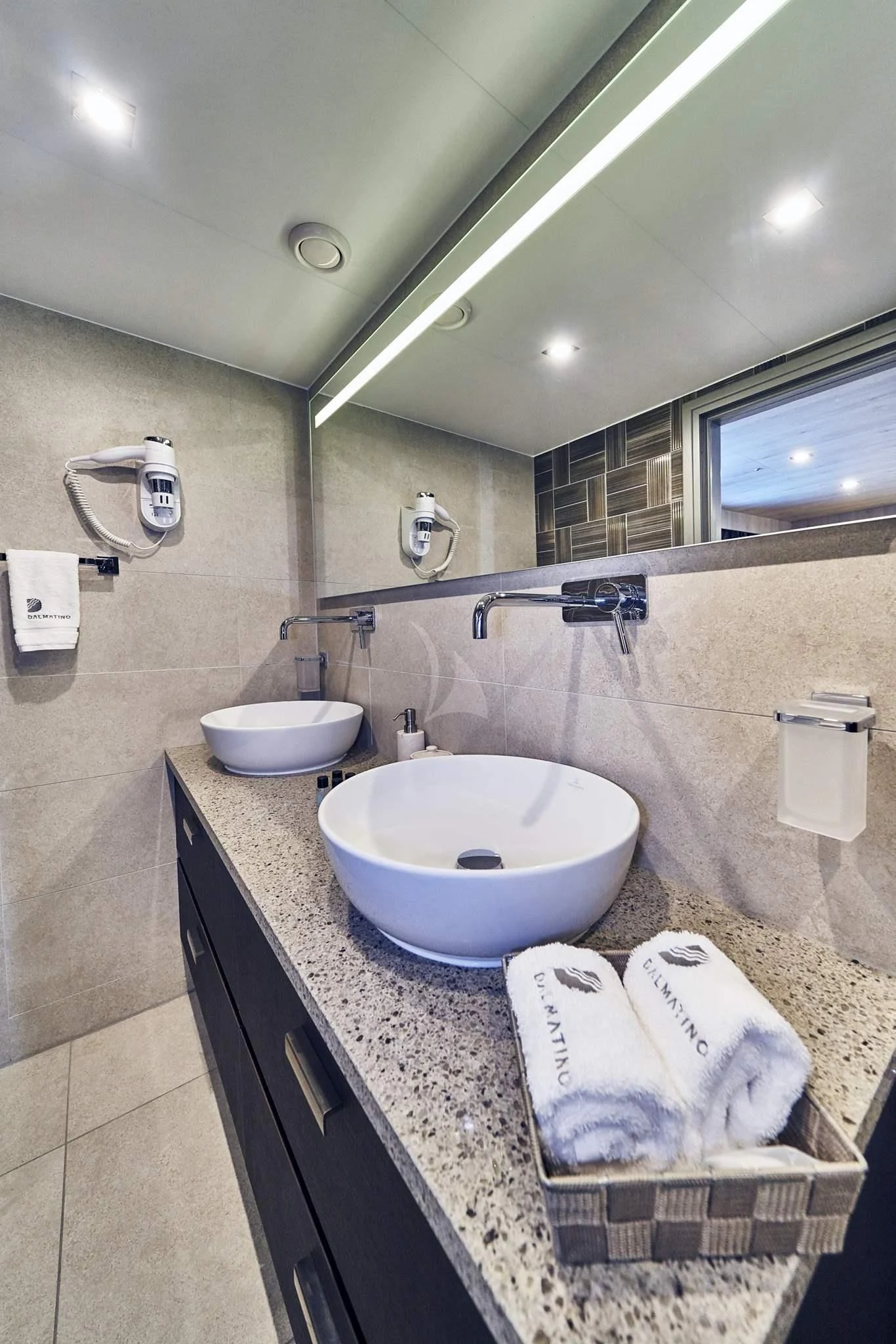 a bathroom with a sink and a mirror aboard DALMATINO Yacht for Sale