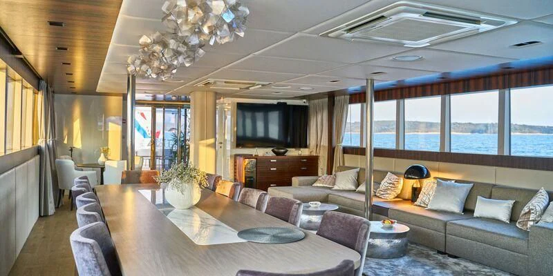 a living room with a large window aboard DALMATINO Yacht for Sale