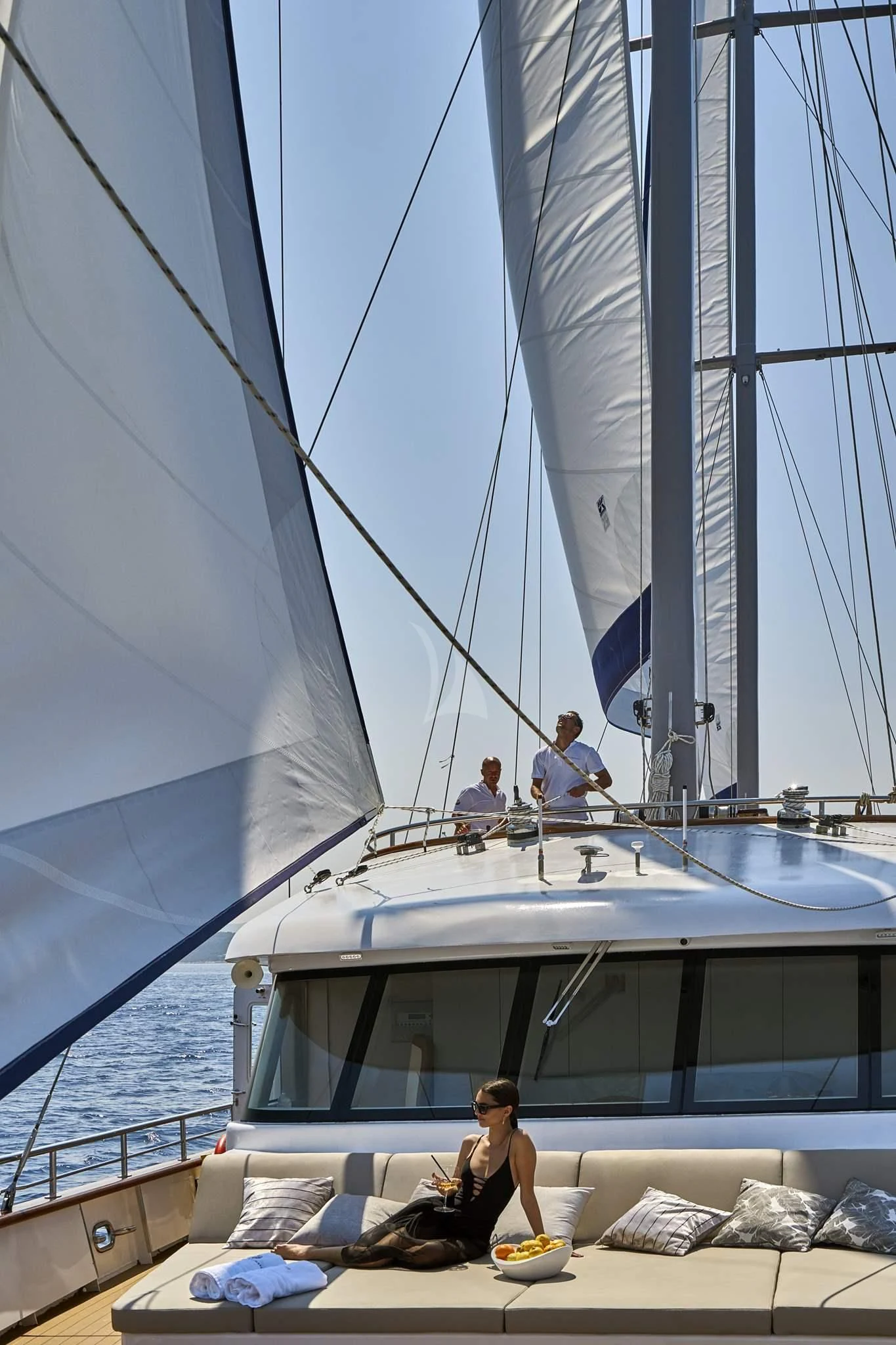 a person sitting on a couch on a boat aboard DALMATINO Yacht for Sale