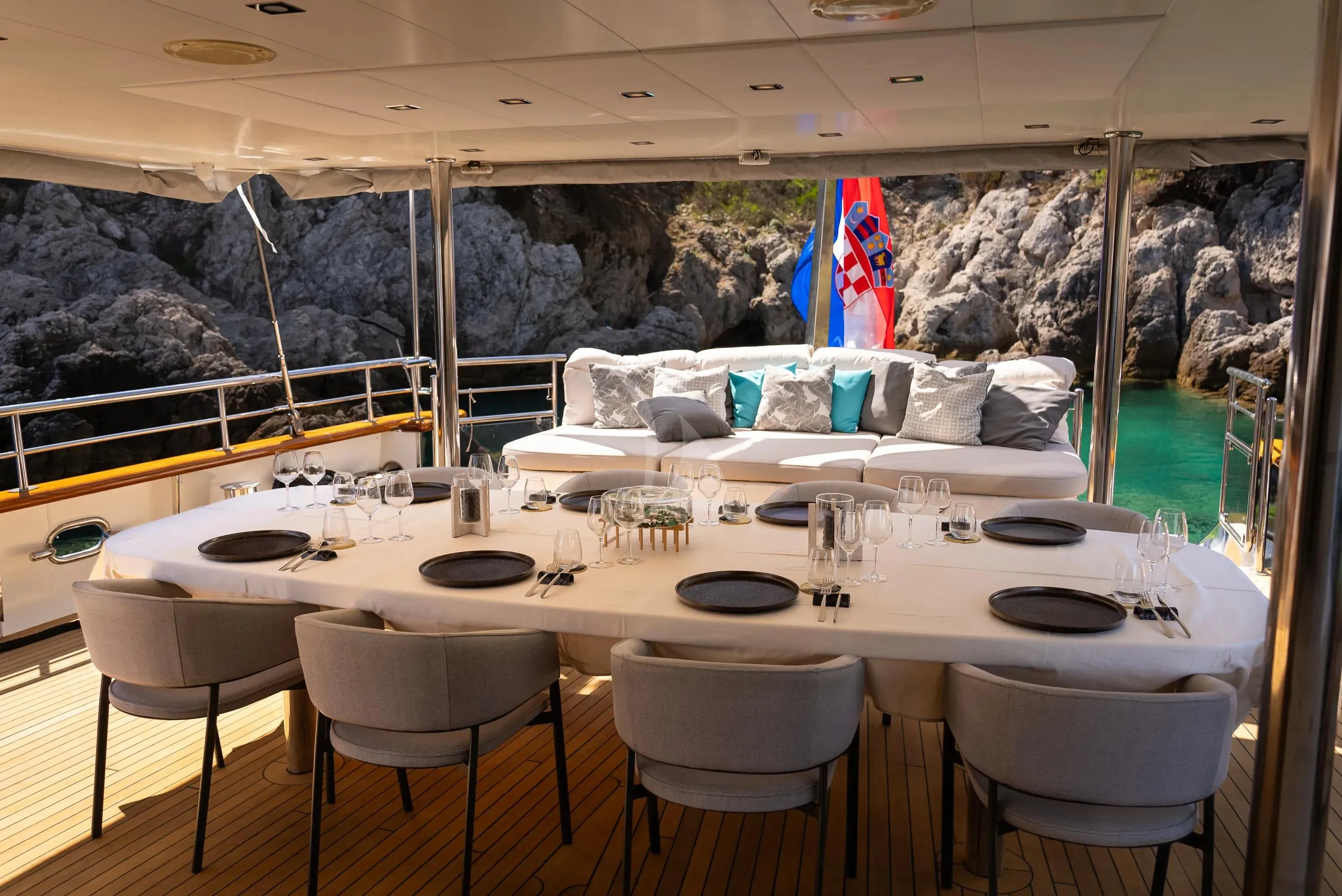 a table with chairs and a large window overlooking a city aboard DALMATINO Yacht for Sale