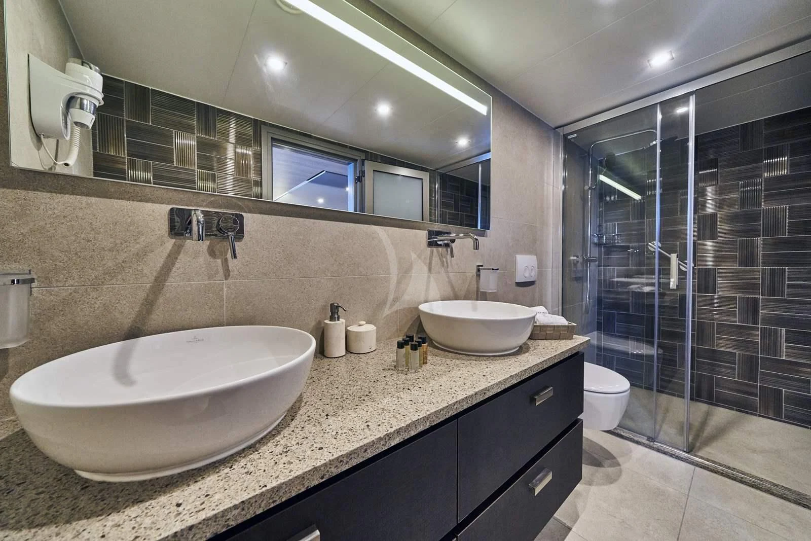 a bathroom with a large mirror aboard DALMATINO Yacht for Sale