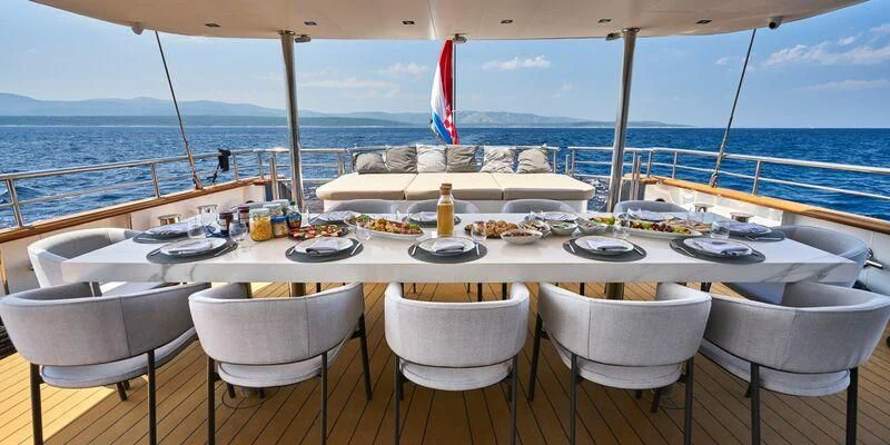 a table set for a meal on a boat aboard DALMATINO Yacht for Sale