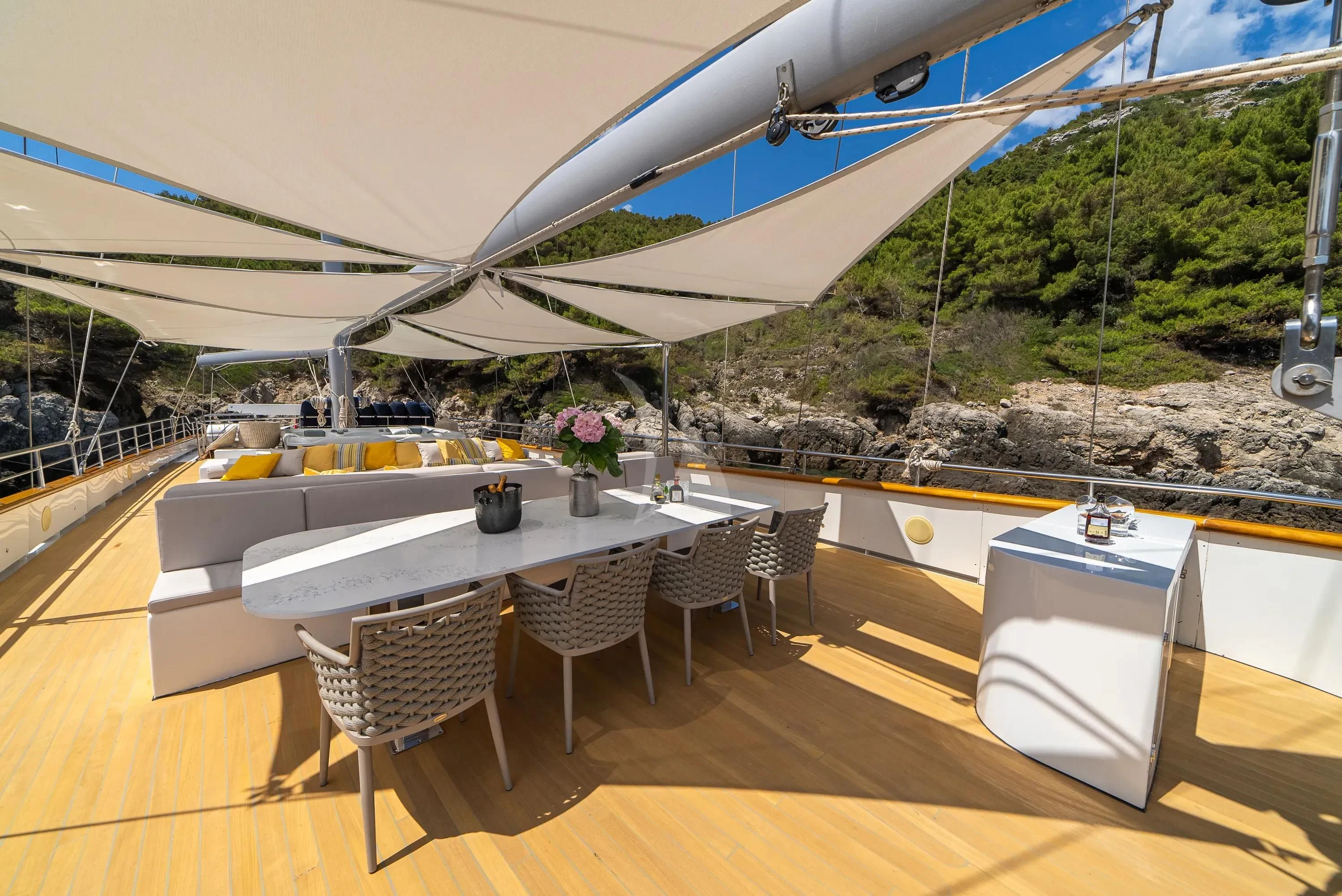 a large white table with chairs around it aboard DALMATINO Yacht for Sale