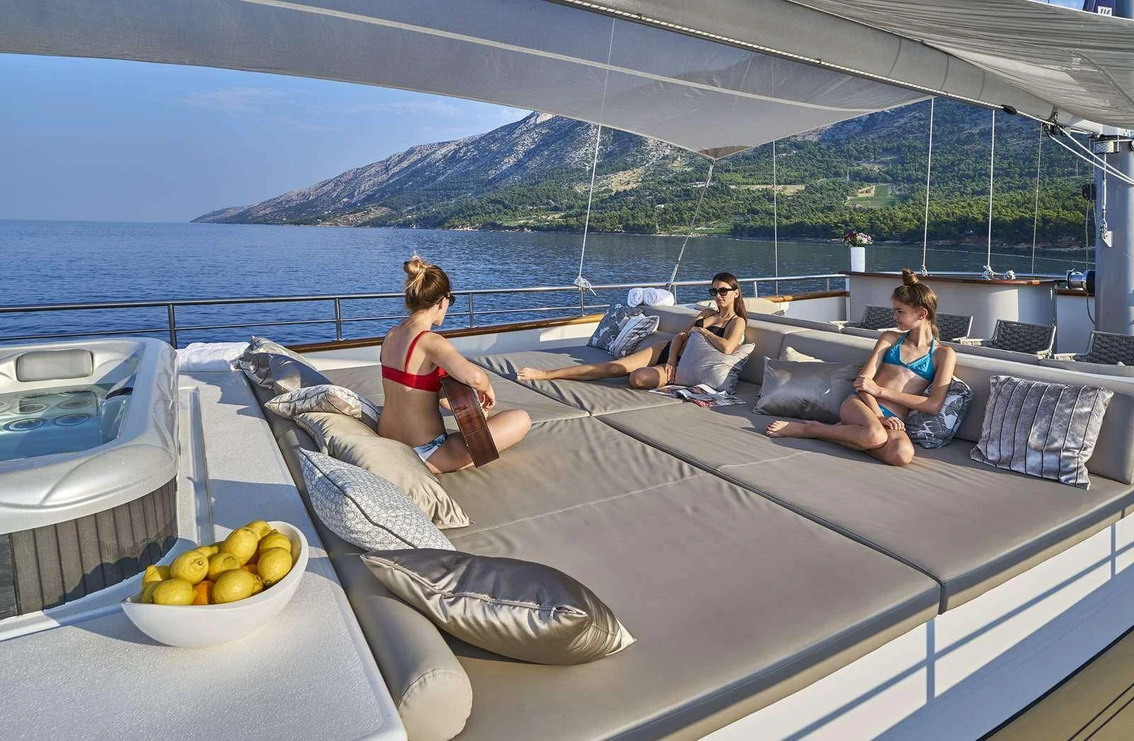 a group of people sitting on a lounge chair on a boat aboard DALMATINO Yacht for Sale