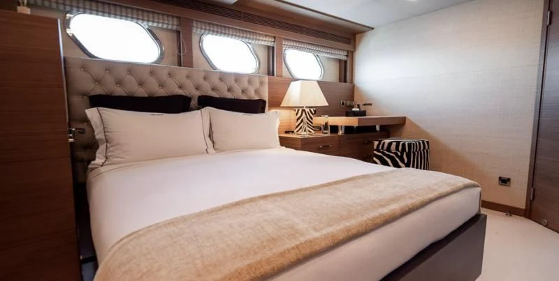a bed with white sheets and pillows aboard QHT Yacht for Sale