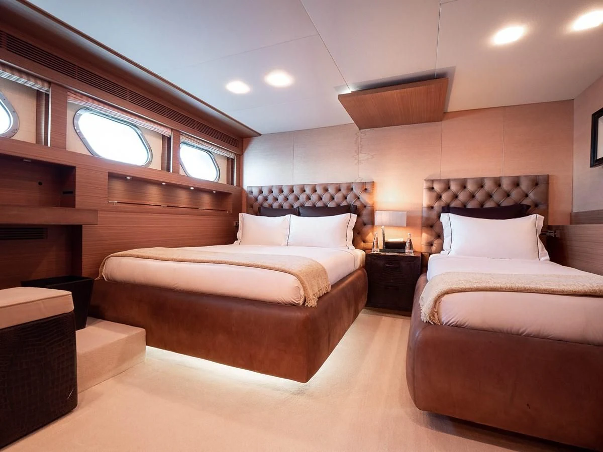 a room with two beds aboard QHT Yacht for Sale