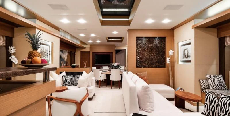 a room with a couch and a tv aboard QHT Yacht for Sale