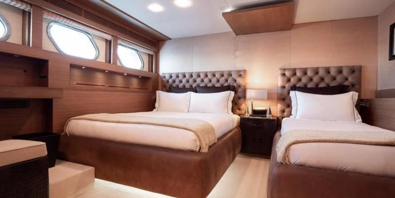 a room with a bed and a window aboard QHT Yacht for Sale
