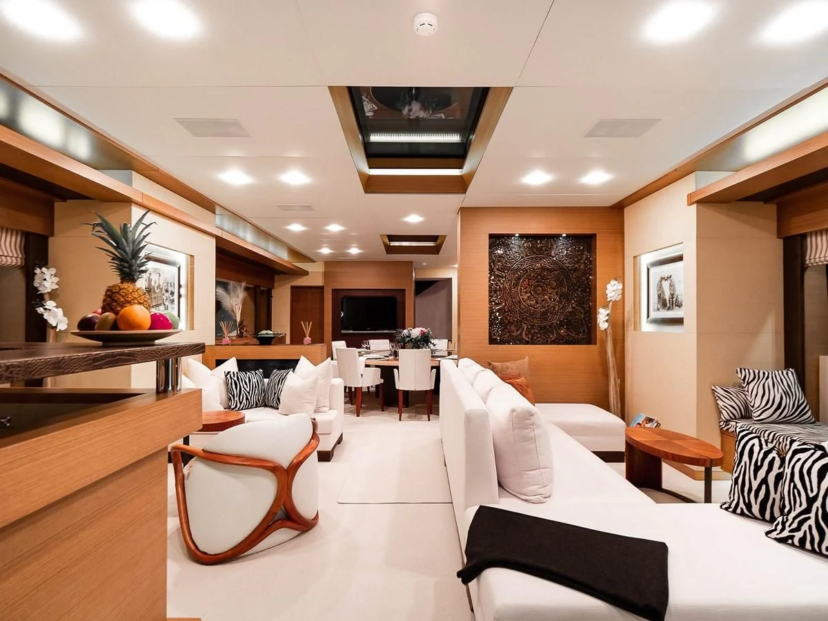 a room with a couch and a table and chairs aboard QHT Yacht for Sale