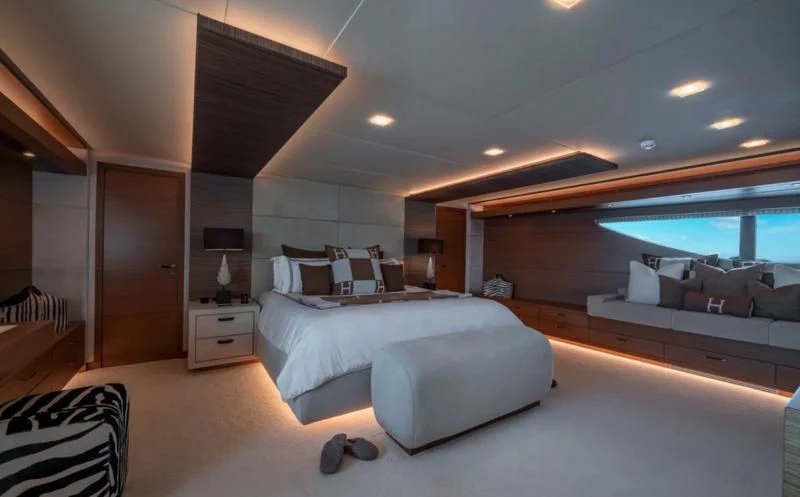 a room with a bed and a window aboard QHT Yacht for Sale