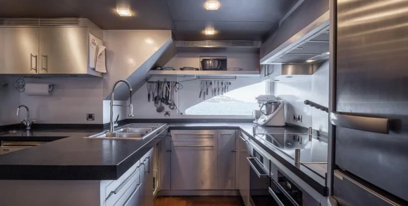 a kitchen with stainless steel appliances aboard QHT Yacht for Sale