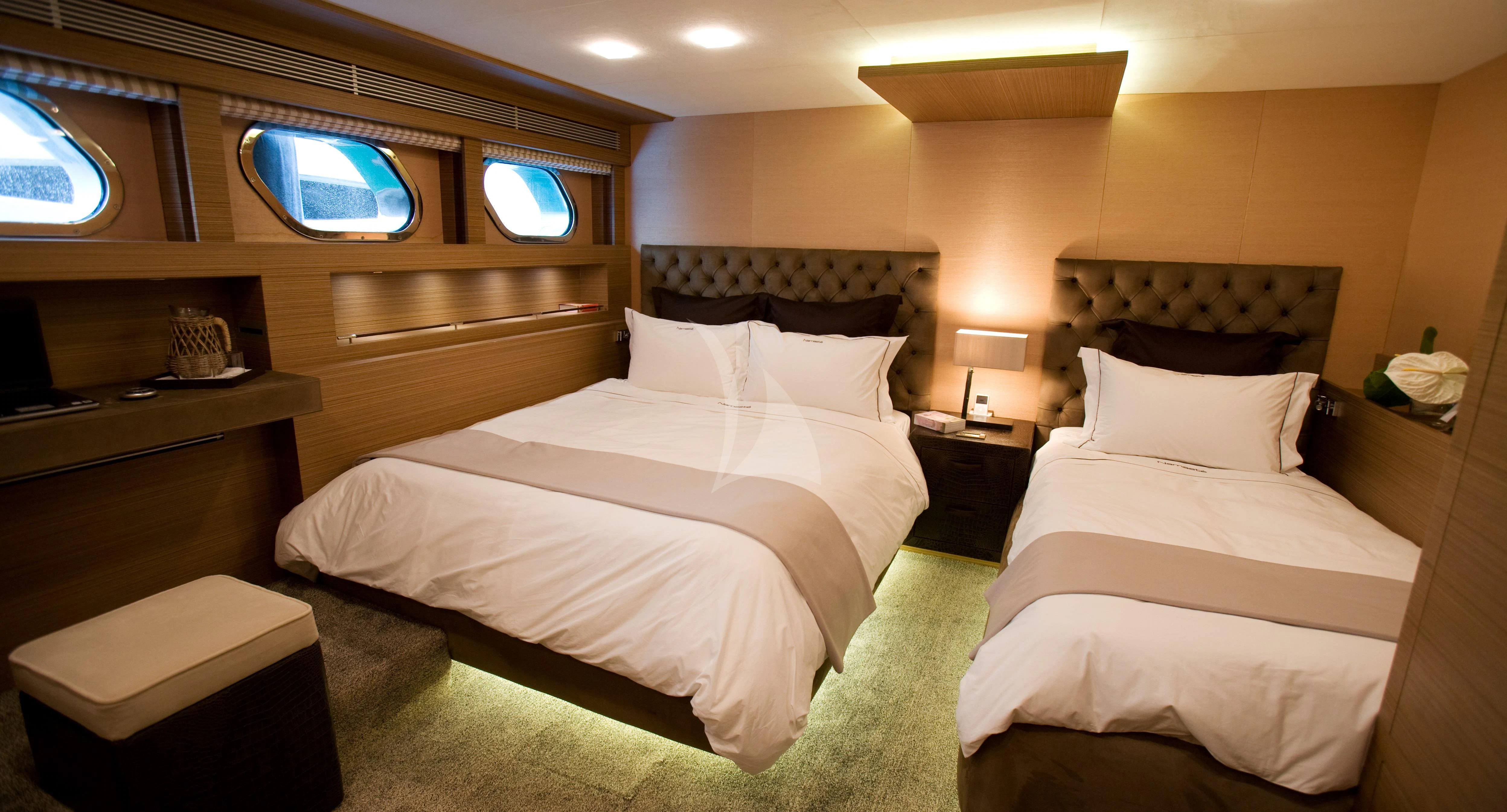 a room with a couple of beds aboard QHT Yacht for Sale