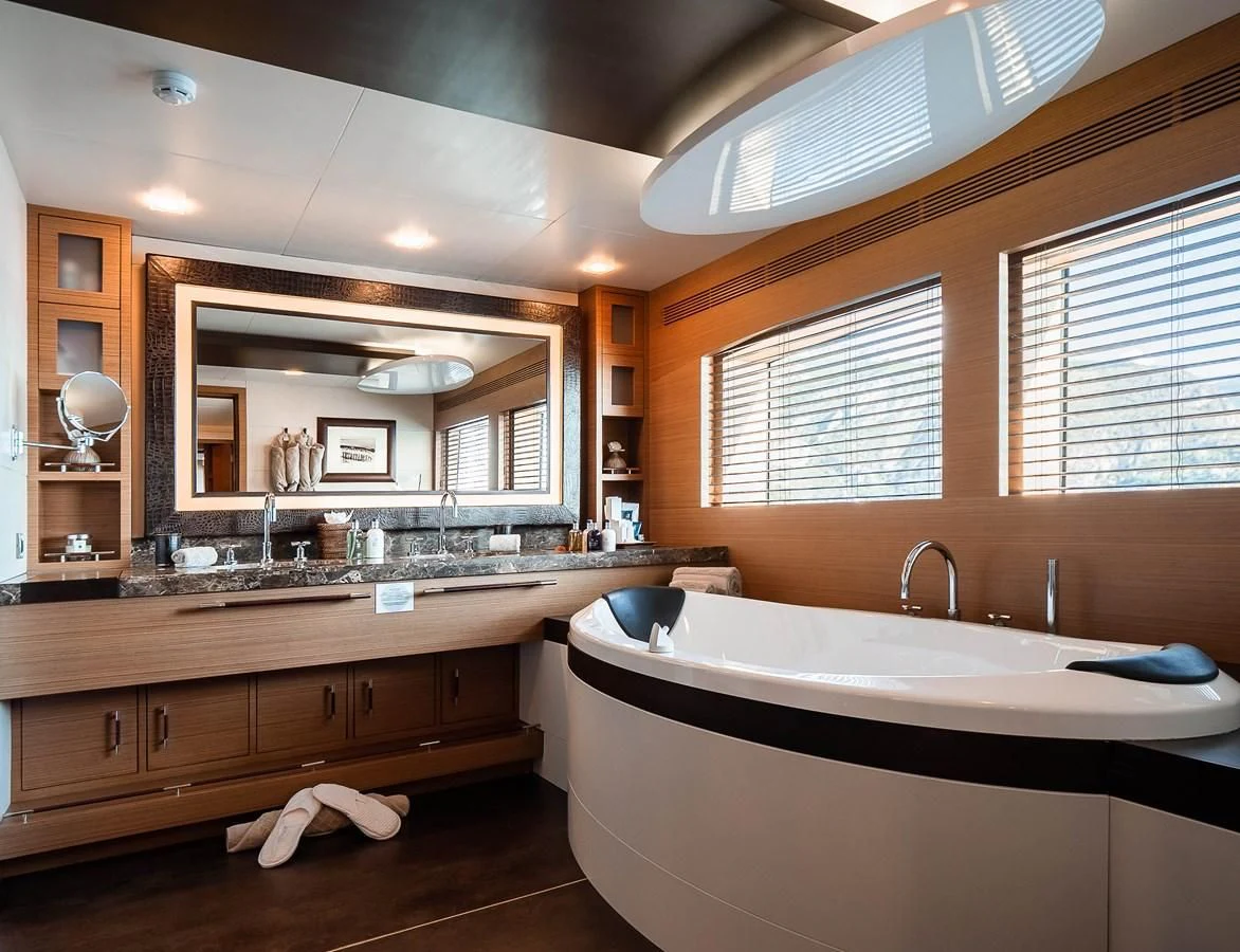 a bathroom with a large mirror aboard QHT Yacht for Sale