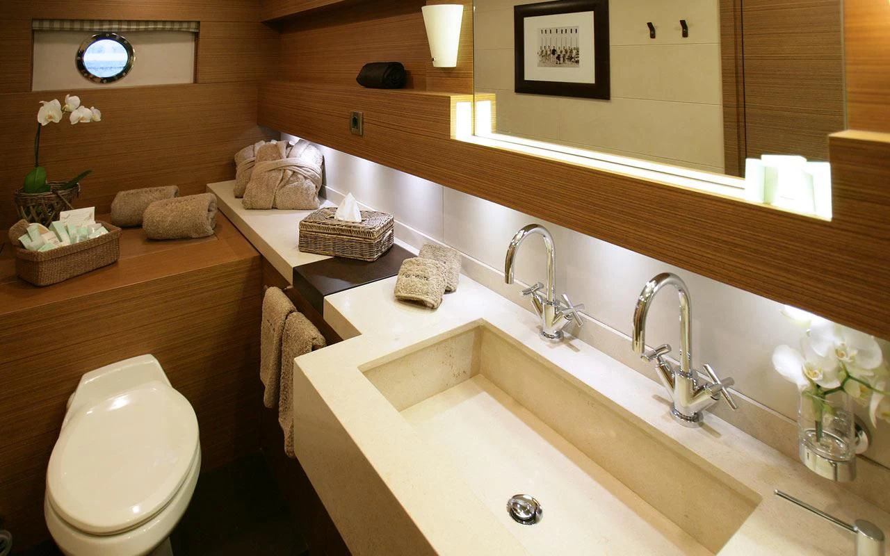 a bathroom with a toilet sink and a mirror aboard QHT Yacht for Sale
