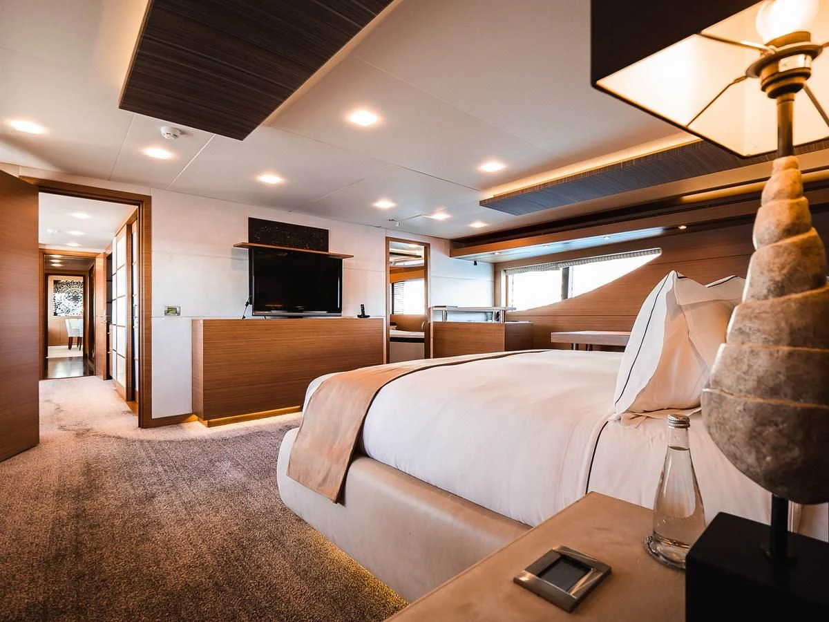 a hotel room with a bed and a desk aboard QHT Yacht for Sale