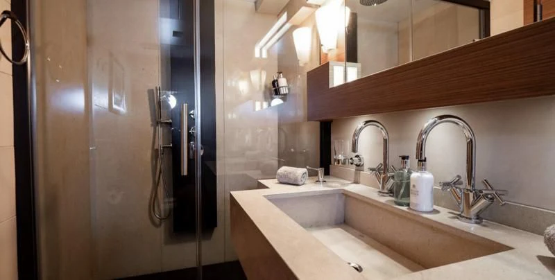 a bathroom with a sink and a mirror aboard QHT Yacht for Sale