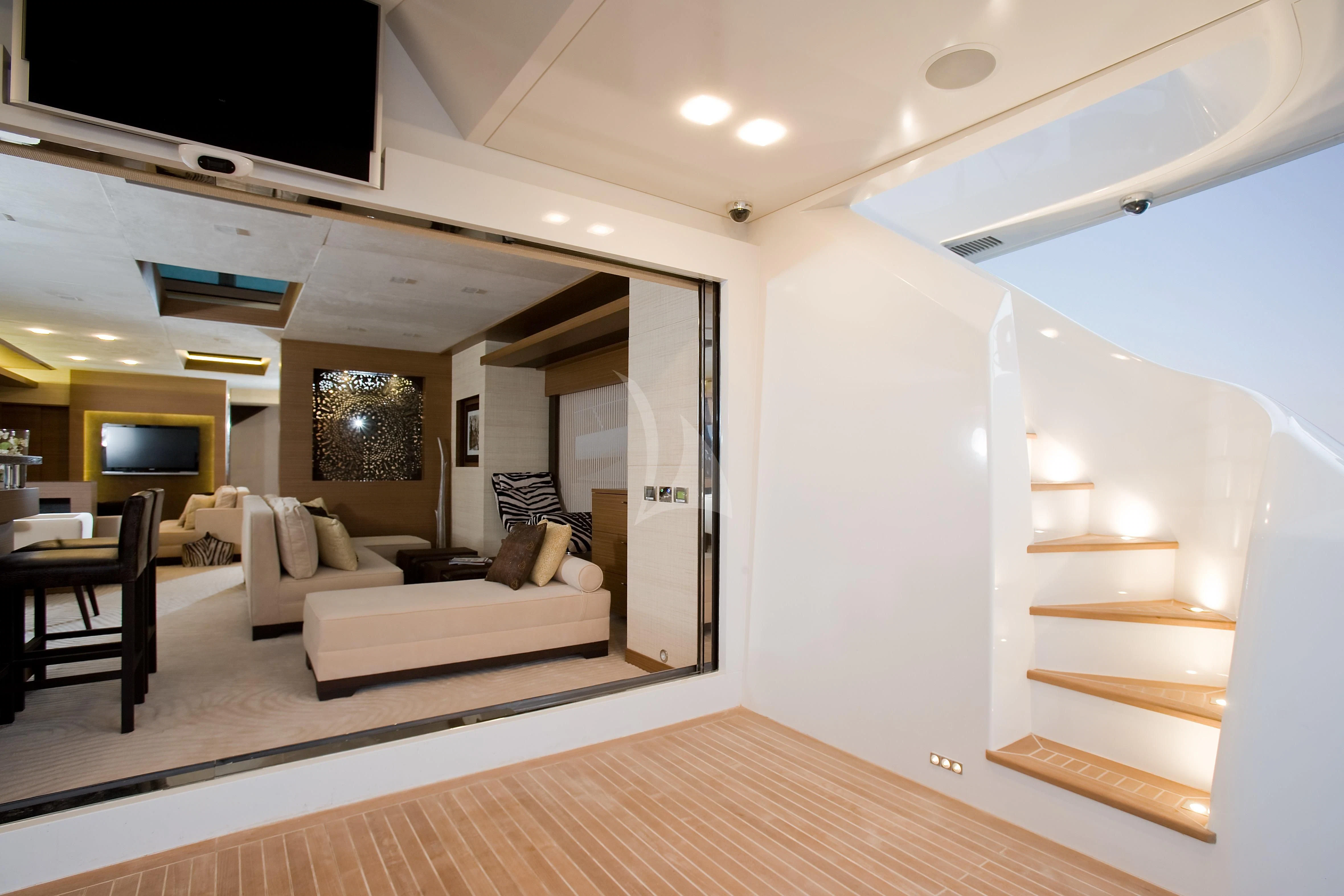 a living room with a wood floor aboard QHT Yacht for Sale