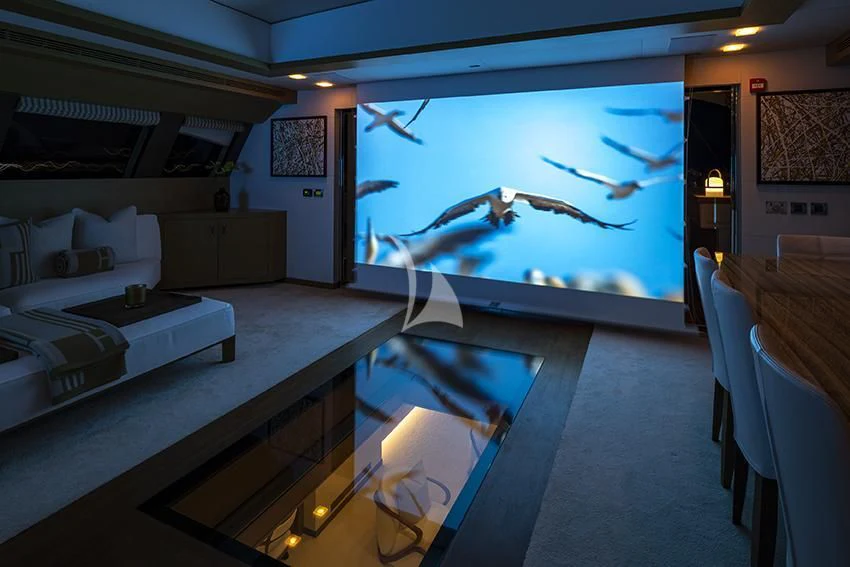 a room with a large screen aboard QHT Yacht for Sale