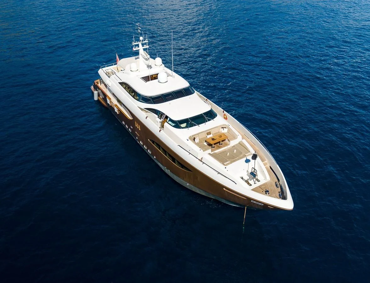 a white boat in the water aboard QHT Yacht for Sale