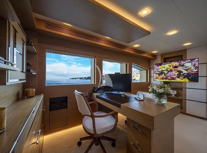 a room with a desk and a computer aboard QHT Yacht for Sale