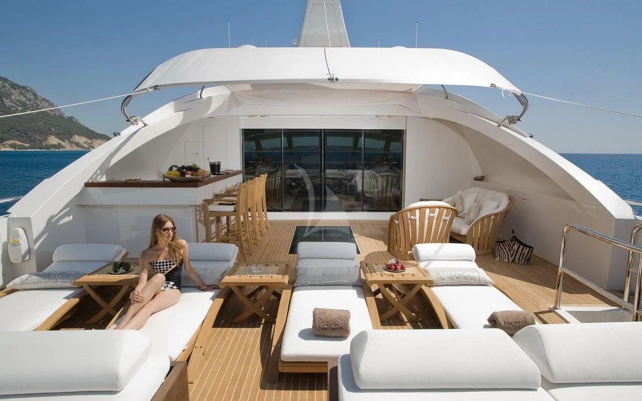 a person sitting on a couch on a boat aboard QHT Yacht for Sale